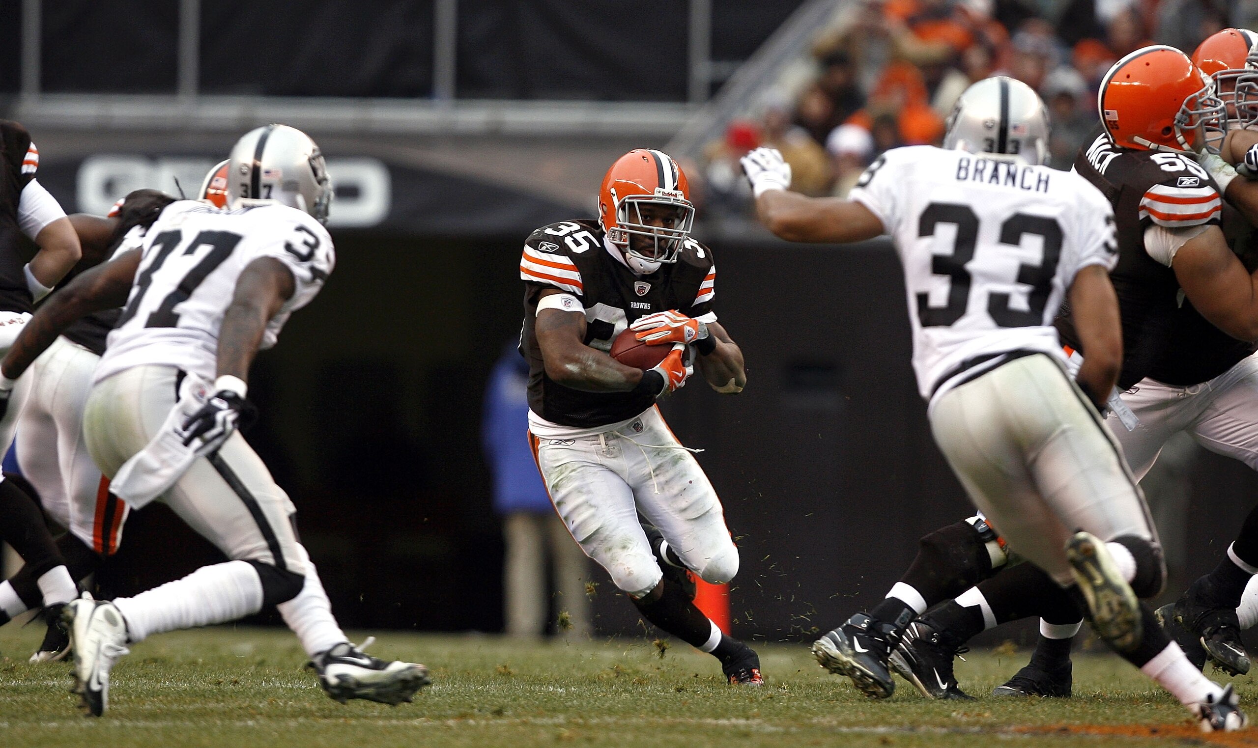 CLEVELAND - DECEMBER 27: Jerome Harrison #35 of the Cleveland Browns runs at Tyvon Branch #33 and Chris Johnson #37 of the Oakland Raiders at Cleveland Browns Stadium on December 27, 2009 in Cleveland, Ohio. (Photo by Matt Sullivan/Getty Images) CLEVELAND - DECEMBER 27: Jerome Harrison #35 of the Cleveland Browns runs at Tyvon Branch #33 and Chris Johnson #37 of the Oakland Raiders at Cleveland Browns Stadium on December 27, 2009 in Cleveland, Ohio. (Photo by Matt Sullivan/Getty Images)