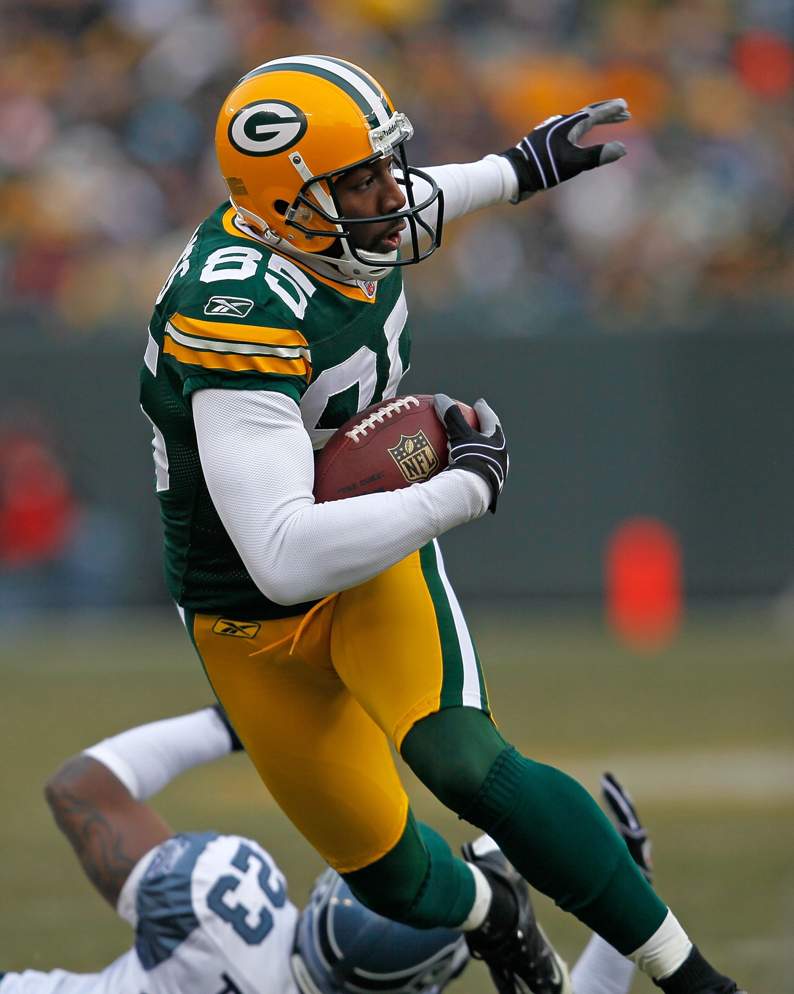 GREEN BAY, WI - DECEMBER 27: Greg Jennings #85 of the Green Bay Packers breaks away from Marcus Trufant #23 of the Seattle Seahawks for a long gain after a catch at Lambeau Field on December 27, 2009 in Green Bay, Wisconsin. The Packers defeated the Seaha