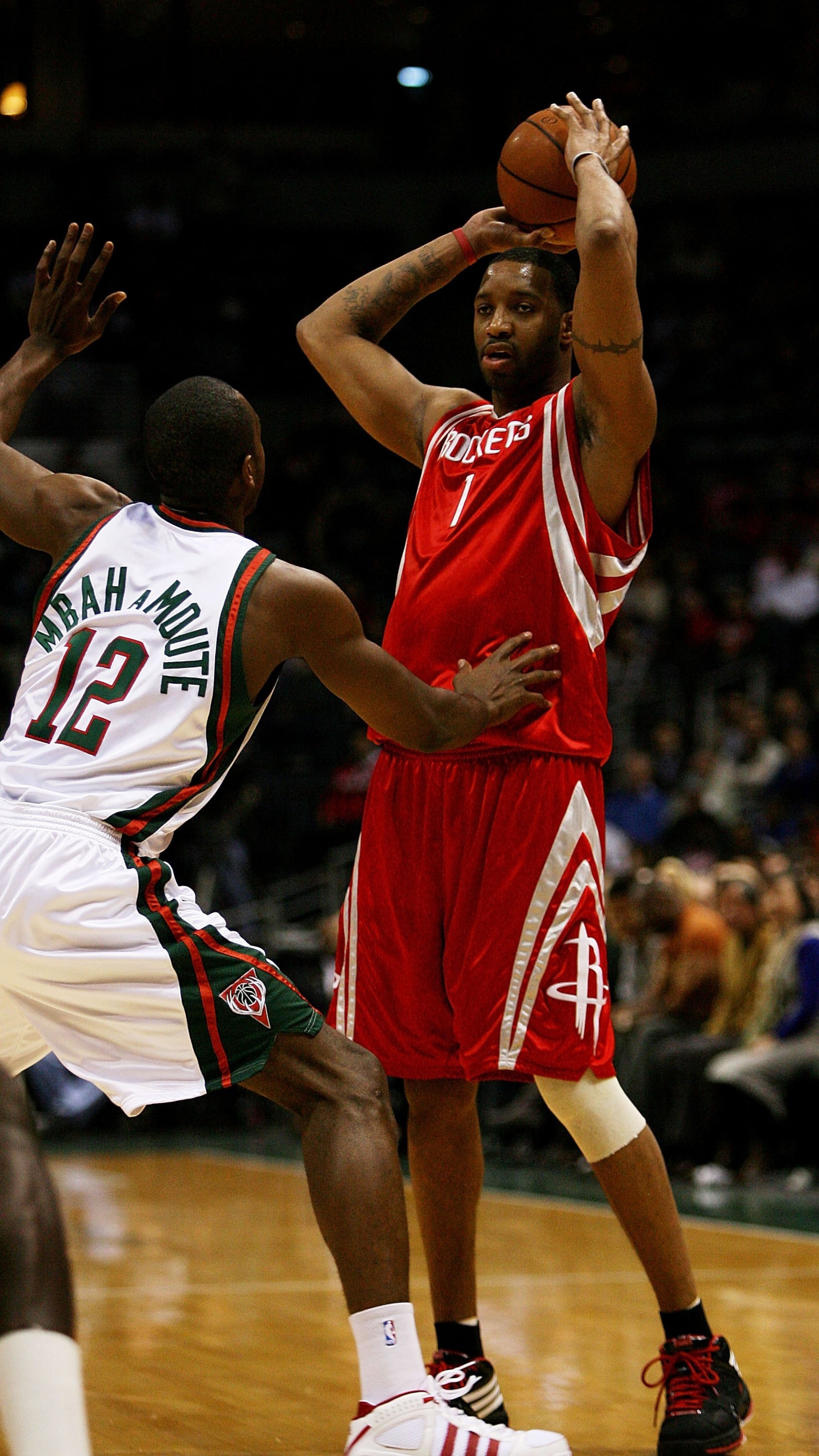 MILWAUKEE - FEBRUARY 09: Tracy McGrady #1 of the Houston Rockets looks to pass over Luc Richard Mbah a Moute #12 of the Milwaukee Bucks on February 9, 2009 at the Bradley Center in Milwaukee, Wisconsin. The Bucks defeated the Rockets 124-112. NOTE TO USER