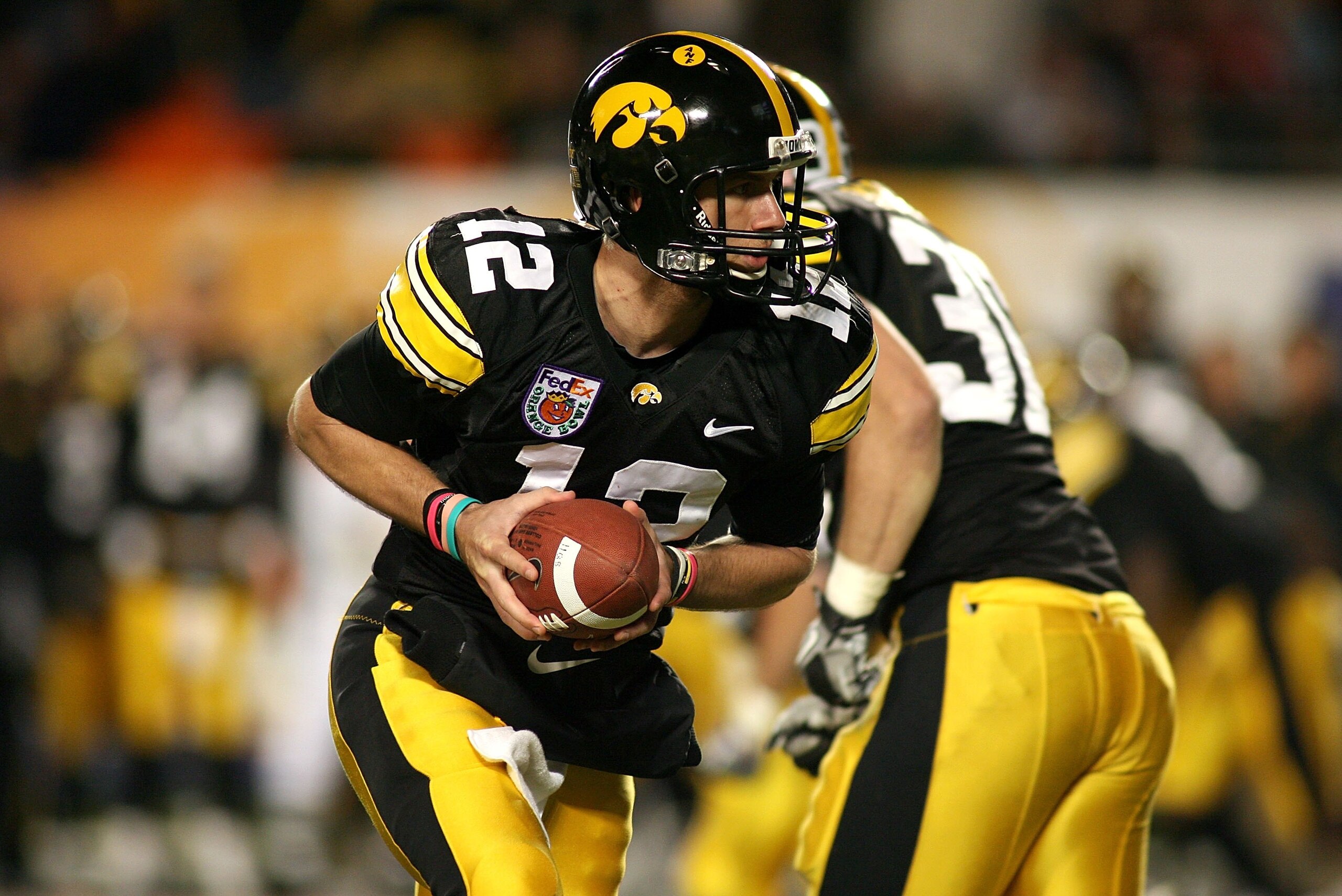 MIAMI GARDENS, FL - JANUARY 05:  Quarterback Richy Stanzi #12 of the Iowa Hawkeyes turns to hand the ball off against the Georgia Tech Yellow Jackets during the FedEx Orange Bowl at Land Shark Stadium on January 5, 2010 in Miami Gardens, Florida. Iowa won