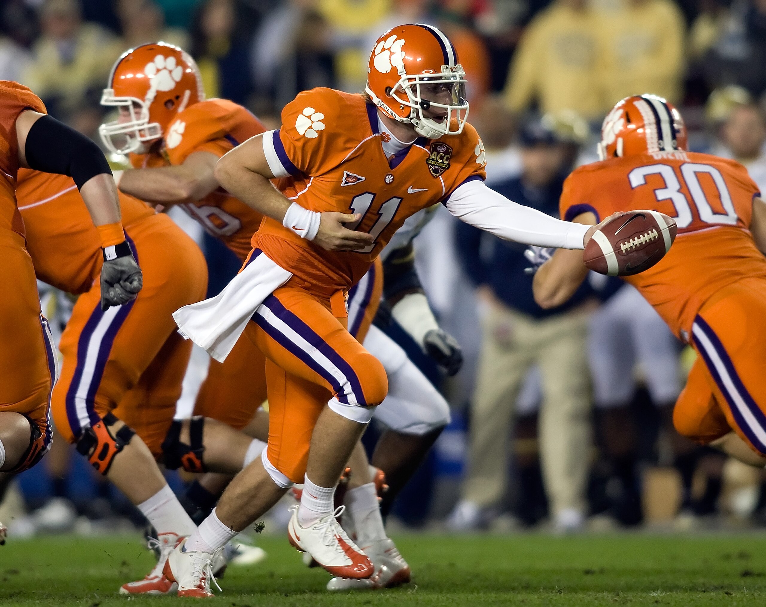 TAMPA - DECEMBER 05: Quarterback Kyle Parker #11 of the Clemson Tigers hands the ball off against the Georgia Tech Yellow Jackets in the 2009 ACC Football Championship game at Raymond James Stadium on December 5, 2009 in Tampa, Florida. (Photo by J. Mer TAMPA - DECEMBER 05: Quarterback Kyle Parker #11 of the Clemson Tigers hands the ball off against the Georgia Tech Yellow Jackets in the 2009 ACC Football Championship game at Raymond James Stadium on December 5, 2009 in Tampa, Florida. (Photo by J. Mer