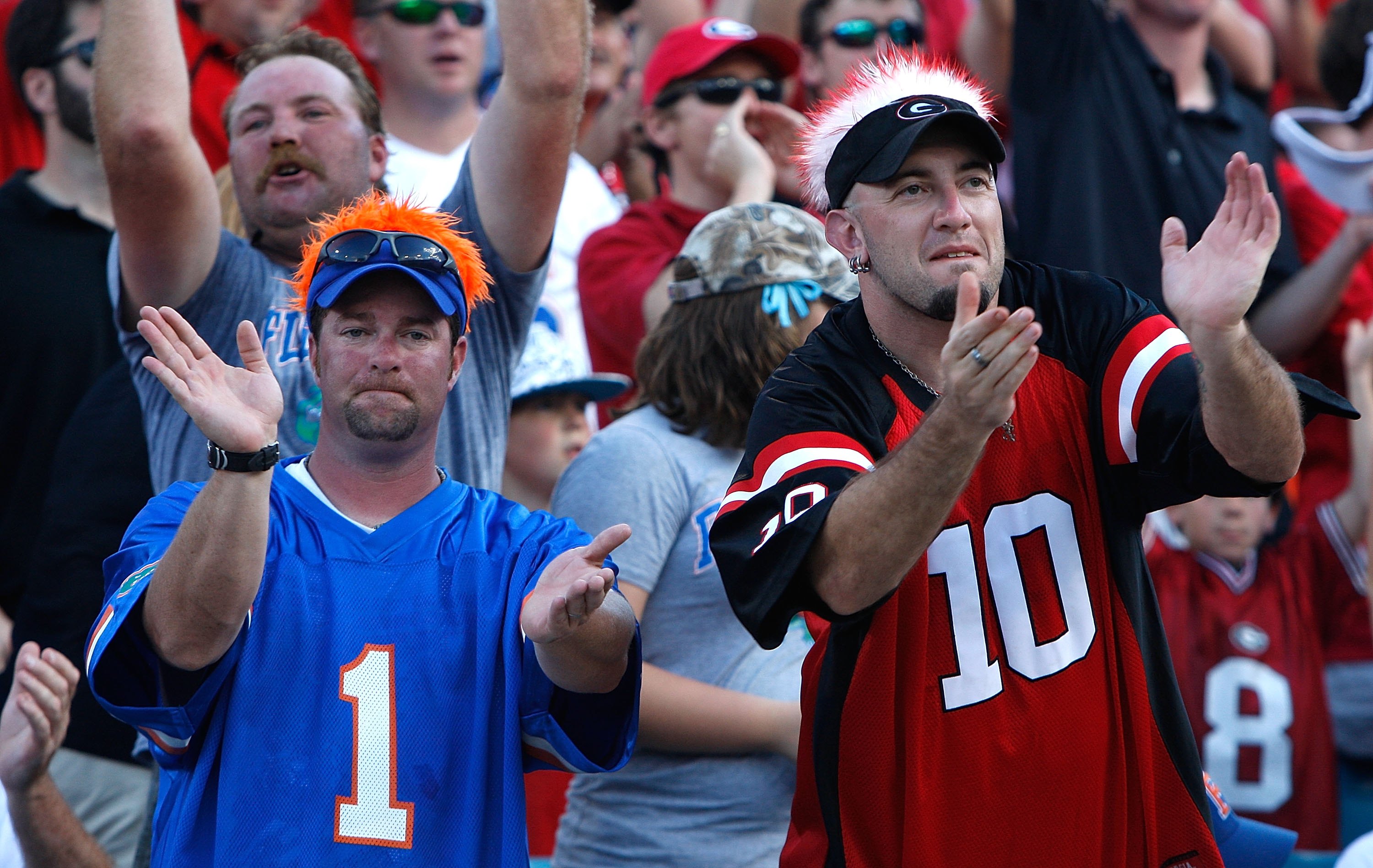 JACKSONVILLE, FL - OCTOBER 31:  A fan of the Florida Gators and a fan of the Georgia Bulldogs cheer beside one another at Jacksonville Municipal Stadium on October 31, 2009 in Jacksonville, Florida.  (Photo by Kevin C. Cox/Getty Images)