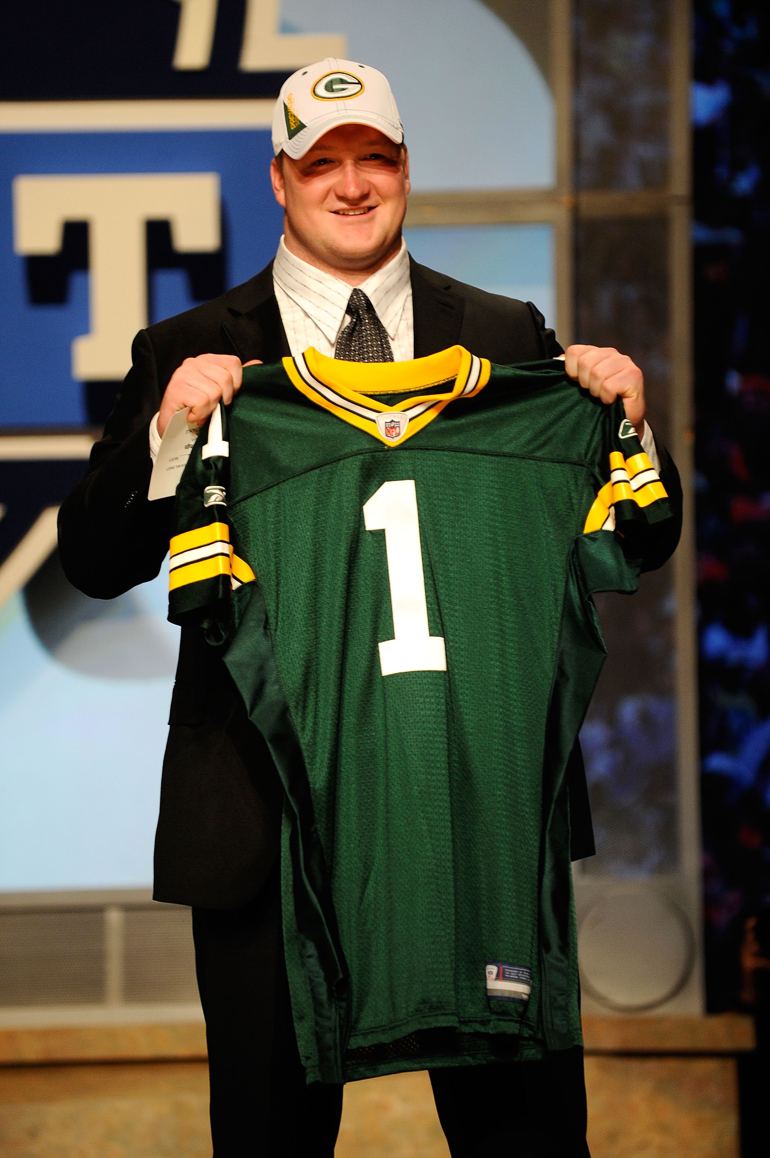 NEW YORK - APRIL 22:  Bryan Bulaga from the Iowa Hawkeyes holds up a Green Bay Packers jersey after the Packers drafted him number 23 overall during the first round of the 2010 NFL Draft at Radio City Music Hall on April 22, 2010 in New York City.  (Photo