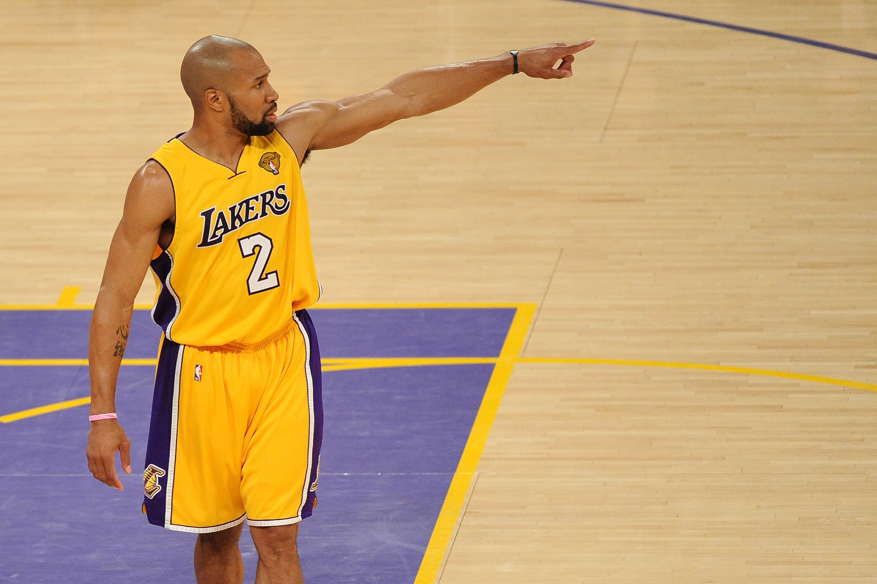 LOS ANGELES, CA - JUNE 15:  Derek Fisher #2 of the Los Angeles Lakers points in the second half while taking on the Boston Celtics in Game Six of the 2010 NBA Finals at Staples Center on June 15, 2010 in Los Angeles, California.  NOTE TO USER: User expres