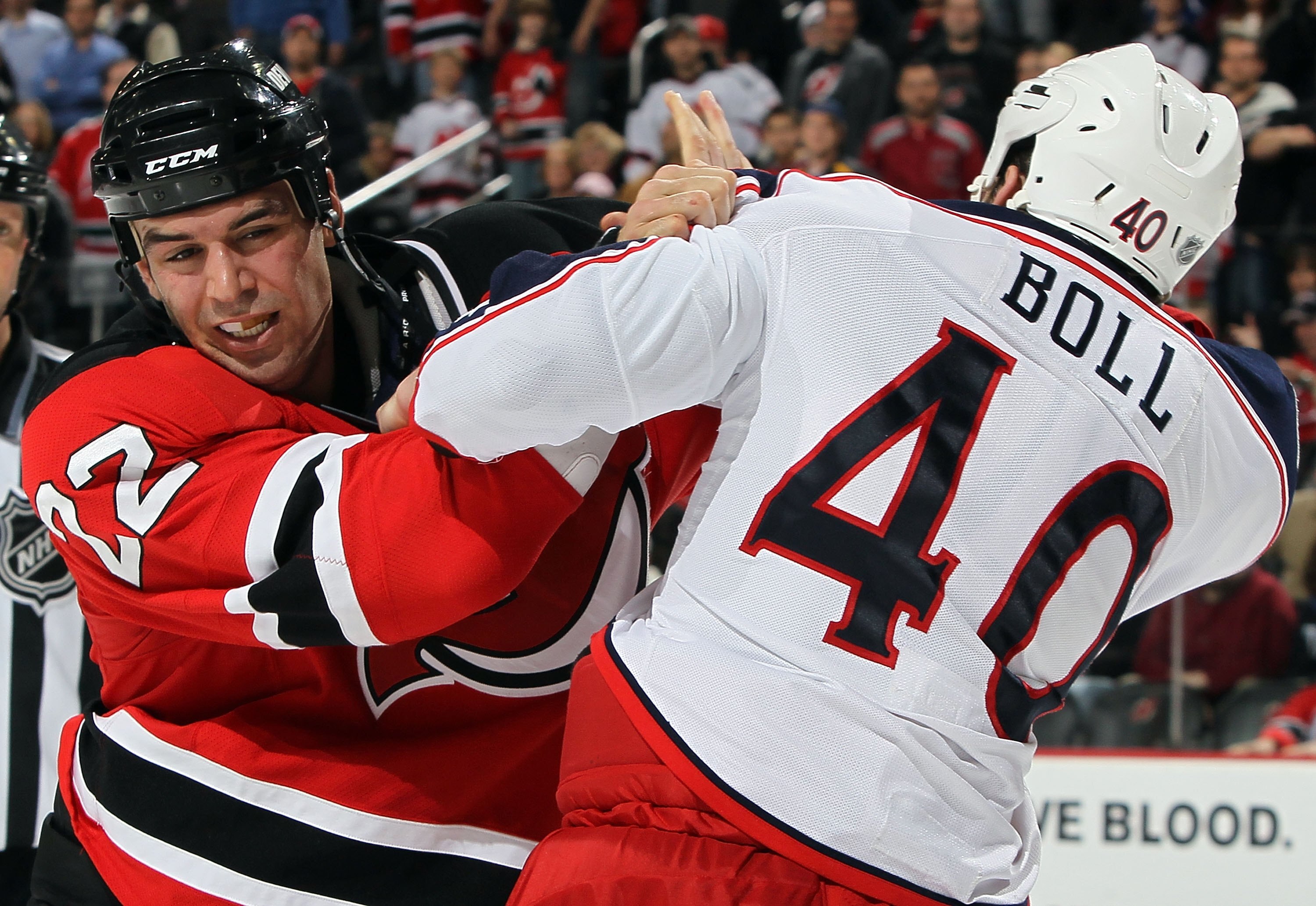 NEWARK, NJ - MARCH 23:  Jared Boll #40 of the Columbus Blue Jackets trades punches with Pierre-Luc Letourneau-Leblond #22 of the New Jersey Devils during their second period fight at the Prudential Center on March 23, 2010 in Newark, New Jersey.  (Photo b