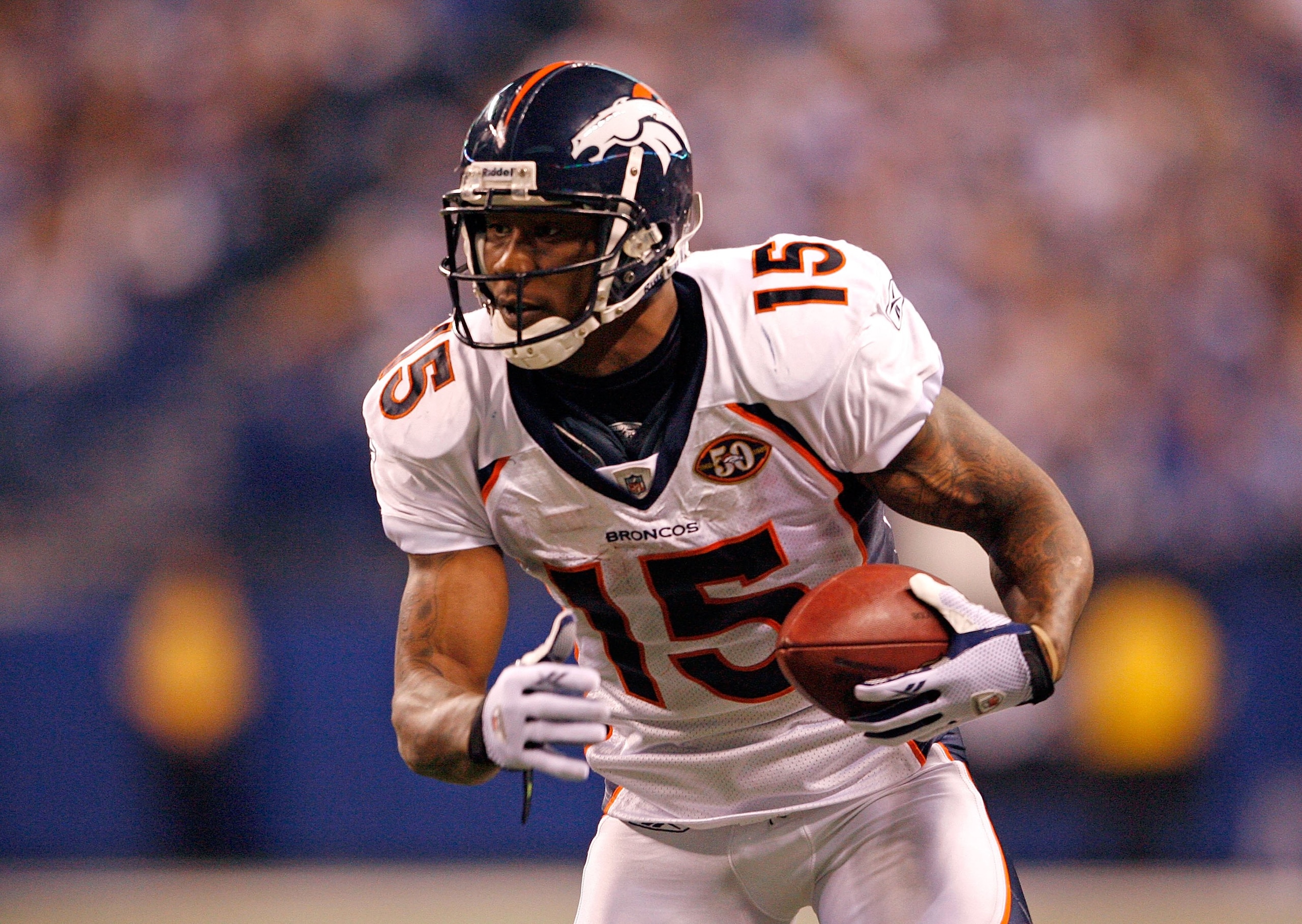 INDIANAPOLIS - DECEMBER 13:  Brandon Marshall #15 of the Denver Broncos runs with the ball during the NFL game against the Indianapolis Colts at Lucas Oil Stadium on December 13, 2009 in Indianapolis, Indiana.  The Colts won 28-16.  (Photo by Andy Lyons/G