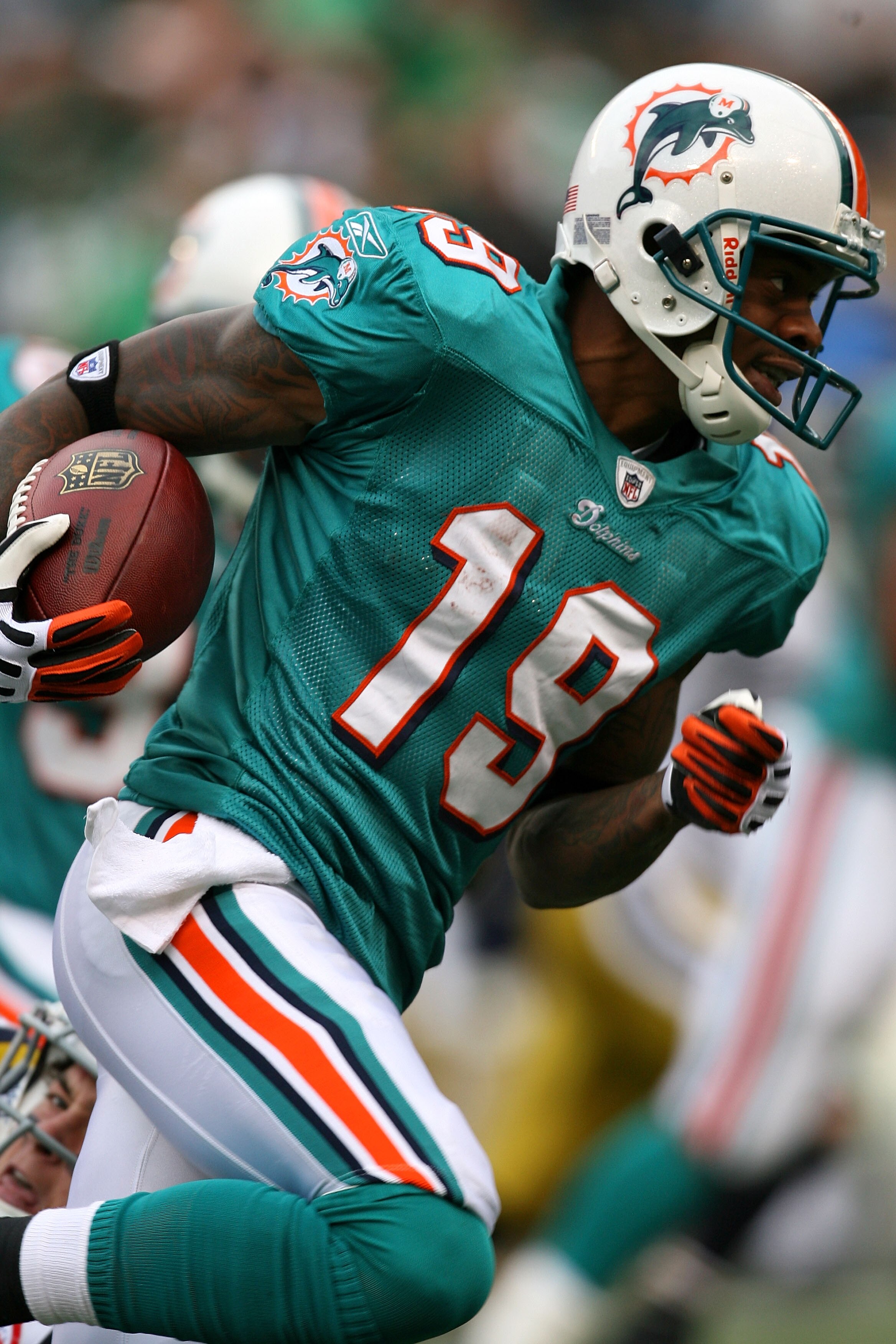 EAST RUTHERFORD, NJ - NOVEMBER 01:  Ted Ginn #19 of the Miami Dolphins returns a kick off during a game against the New York Jets at Giants Stadium on November 1, 2009 in East Rutherford, New Jersey.  (Photo by Chris Trotman/Getty Images)