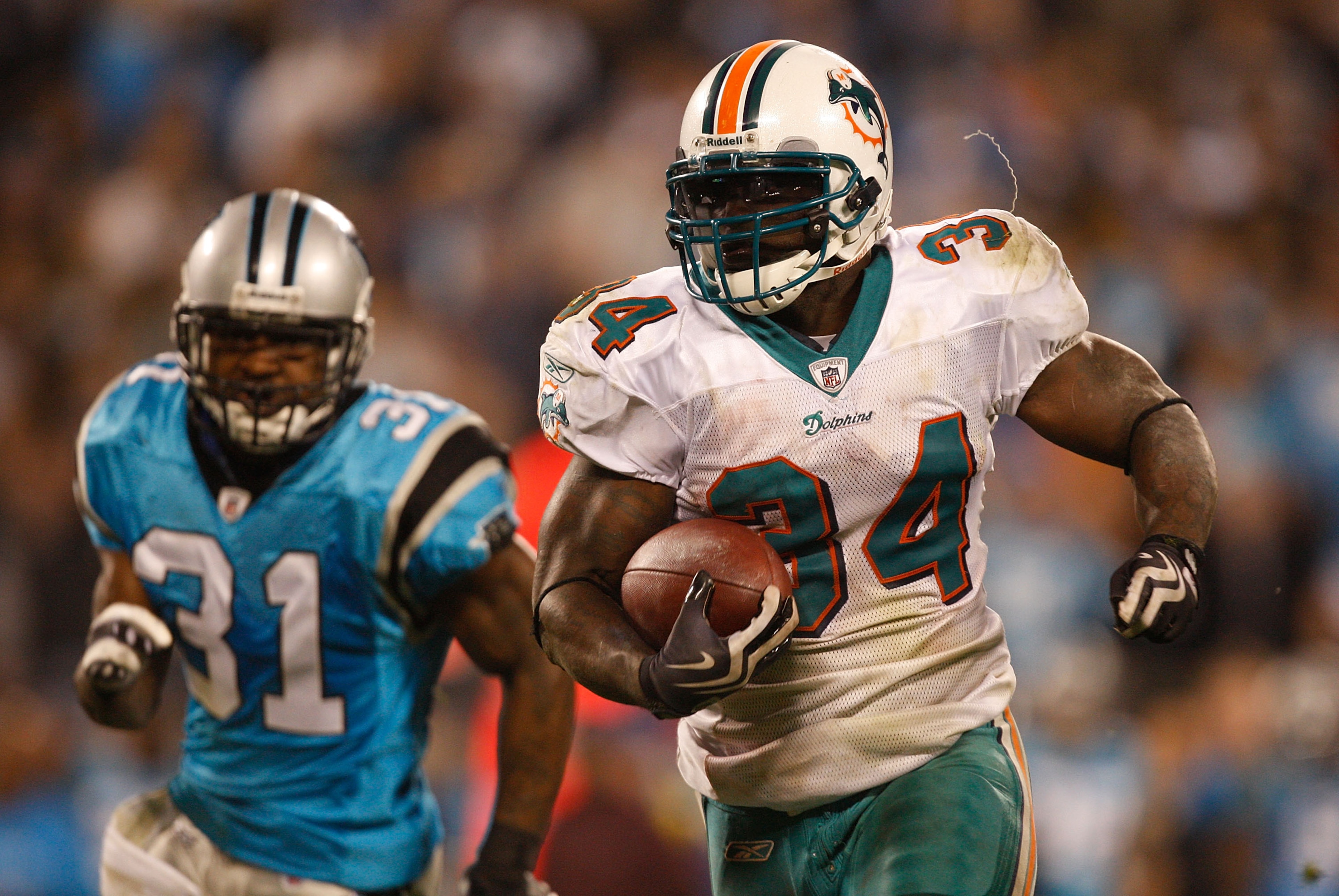 CHARLOTTE, NC - NOVEMBER 19: Ricky Williams #34 of the Miami Dolphins runs away from Richard Marshall #31 of the Carolina Panthers during their game at Bank of America Stadium on November 19, 2009 in Charlotte, North Carolina. (Photo by Streeter Lecka/G CHARLOTTE, NC - NOVEMBER 19: Ricky Williams #34 of the Miami Dolphins runs away from Richard Marshall #31 of the Carolina Panthers during their game at Bank of America Stadium on November 19, 2009 in Charlotte, North Carolina. (Photo by Streeter Lecka/G