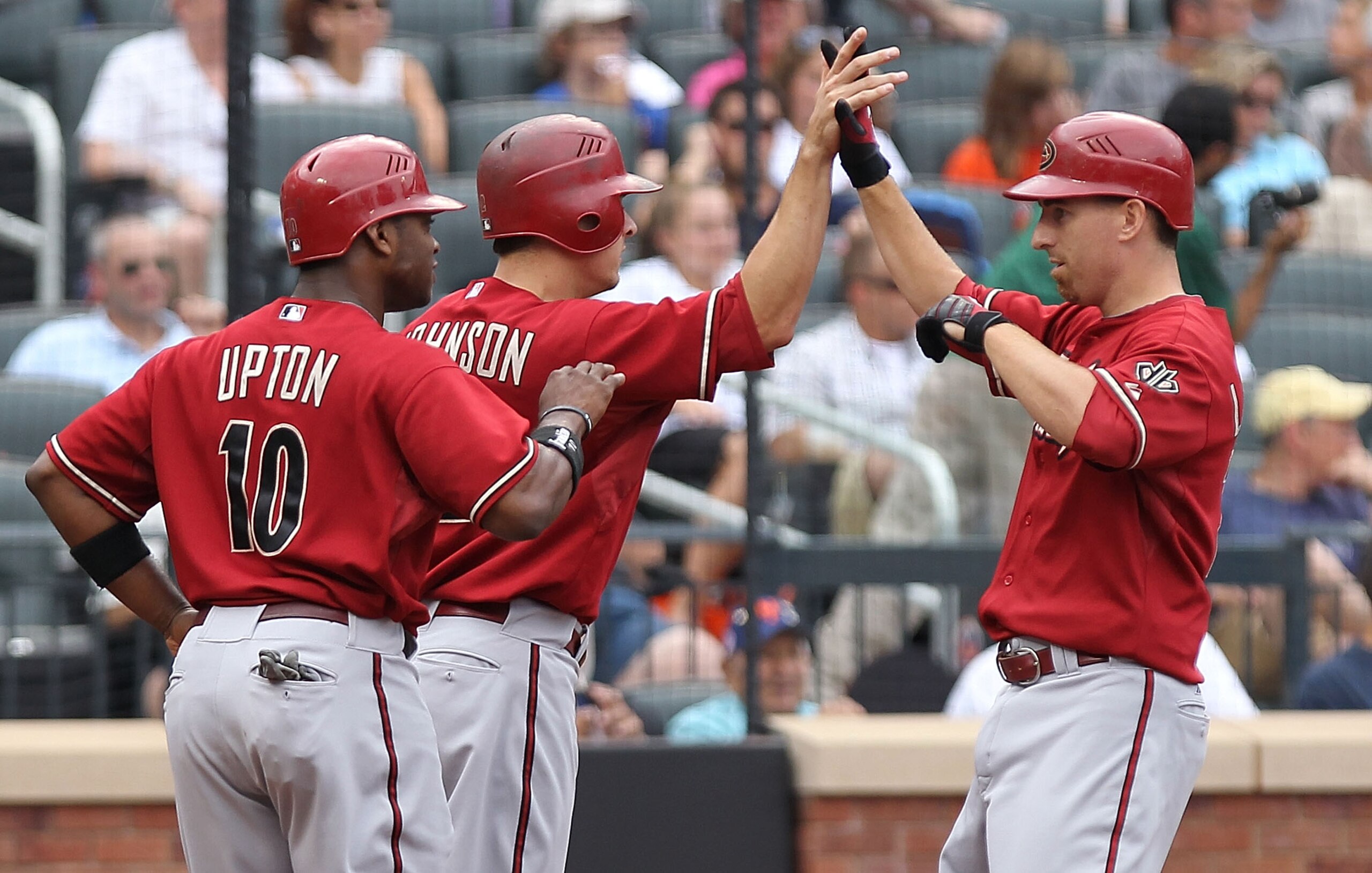 NEW YORK - AUGUST 01: Adam LaRoche #25 of the Arizona Diamondbacks celebrates his second three run home with scoring teammates Kelly Johnson #2 and Justin Upton #10 against the New York Mets at Citi Field on August 1, 2010 in the Flushing neighborhood of NEW YORK - AUGUST 01: Adam LaRoche #25 of the Arizona Diamondbacks celebrates his second three run home with scoring teammates Kelly Johnson #2 and Justin Upton #10 against the New York Mets at Citi Field on August 1, 2010 in the Flushing neighborhood of