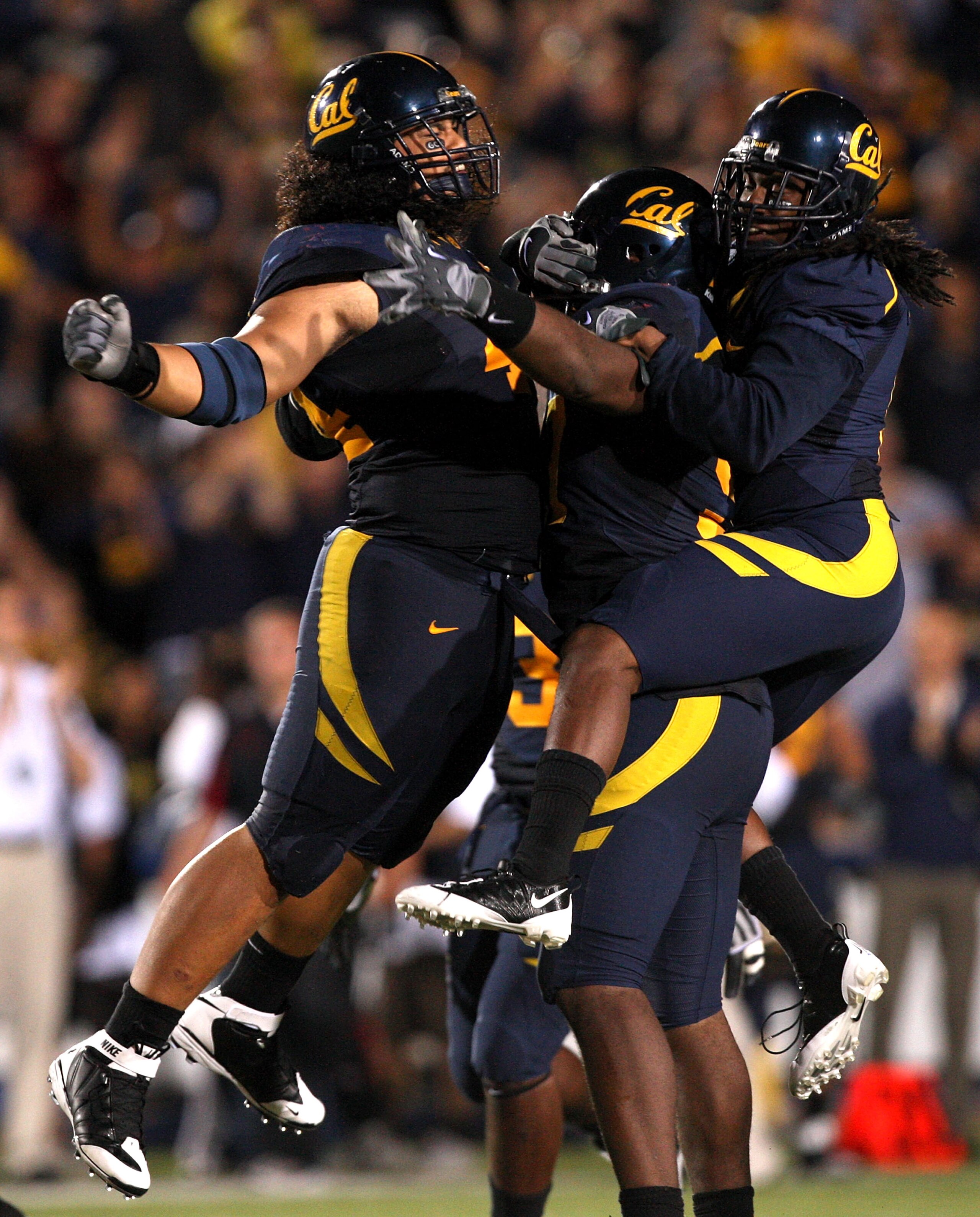 BERKELEY, CA - SEPTEMBER 05:  Tyson Alualu #44, Cameron Jordan #97, and Syd'quan Thompson #5 of the California Golden Bears celebrate after they caused a fumble during the first half of their game against the Maryland Terrapins at California Memorial Stad