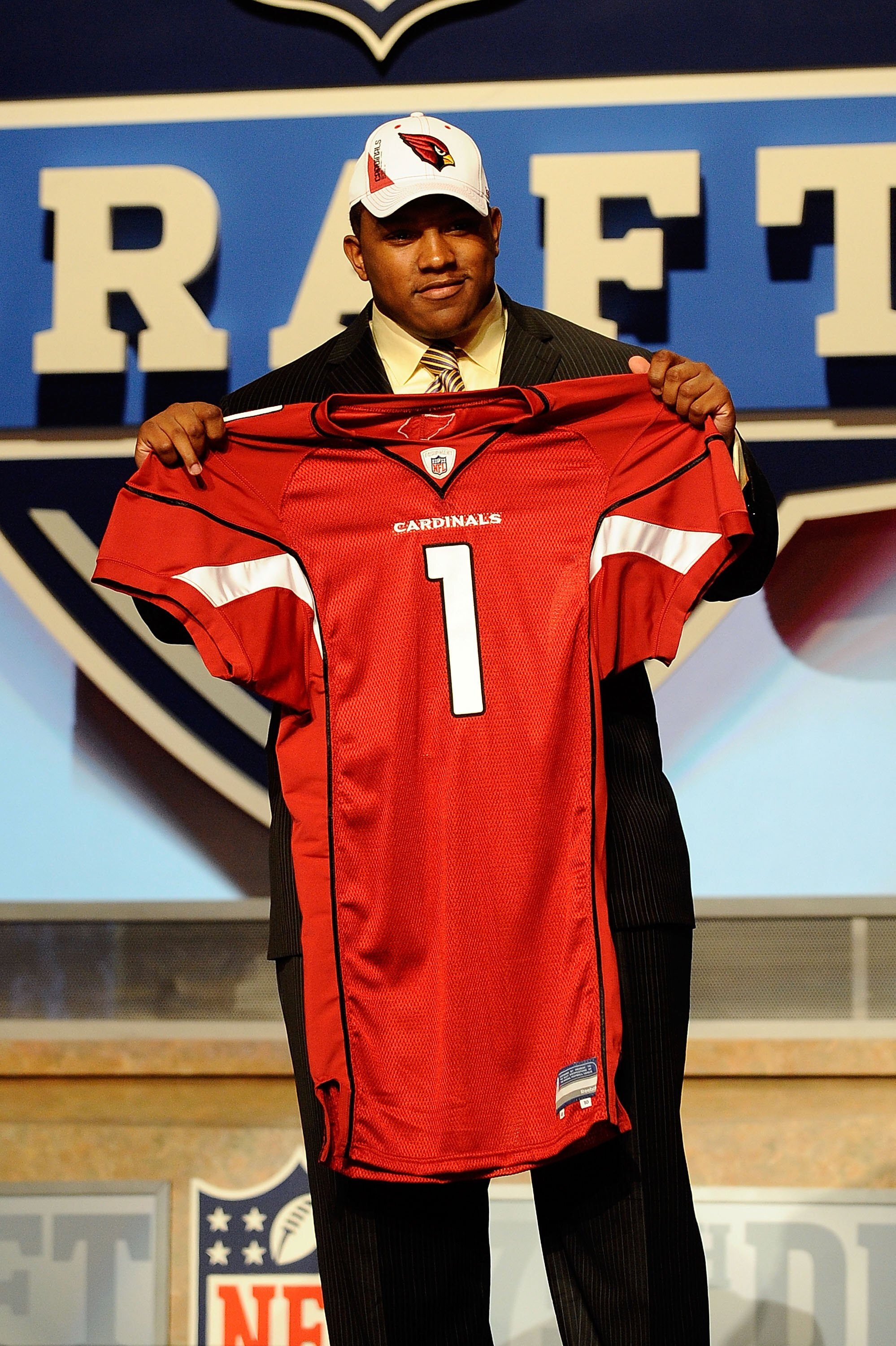 NEW YORK - APRIL 22:  Dan Williams from the Tennessee Volunteers holds up a Arizona Cardinals jersey after he was selected number 26 overall by the Cardinals during the first round of the 2010 NFL Draft at Radio City Music Hall on April 22, 2010 in New Yo