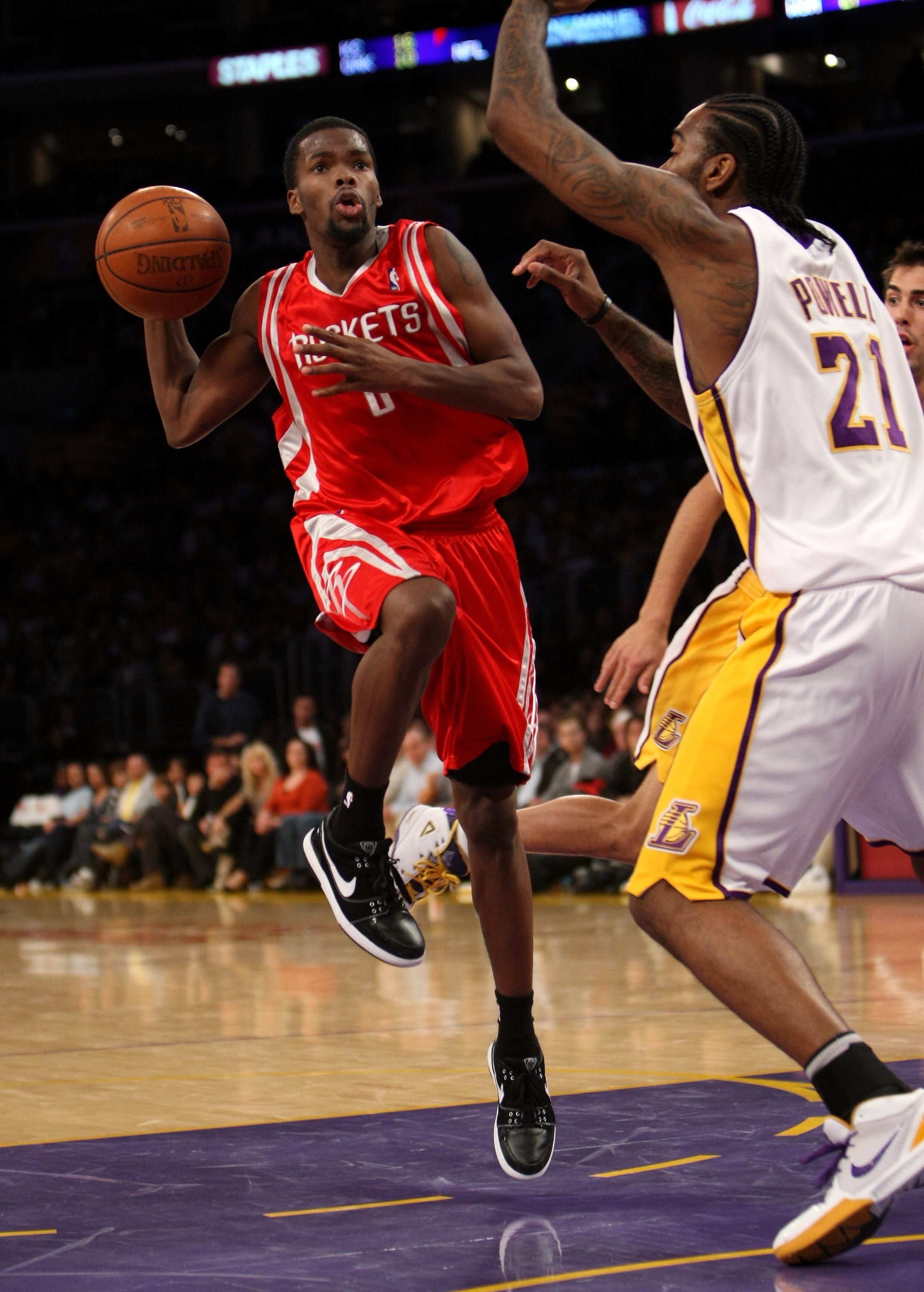 LOS ANGELES, CA - NOVEMBER 15:  Aaron Brooks #0 of the Houston Rockets controls the ball against Josh Powell #21 of the Los Angeles Lakers on November 15, 2009 at Staples Center in Los Angeles, California.  The Rockets won 101-91.  NOTE TO USER: User expr