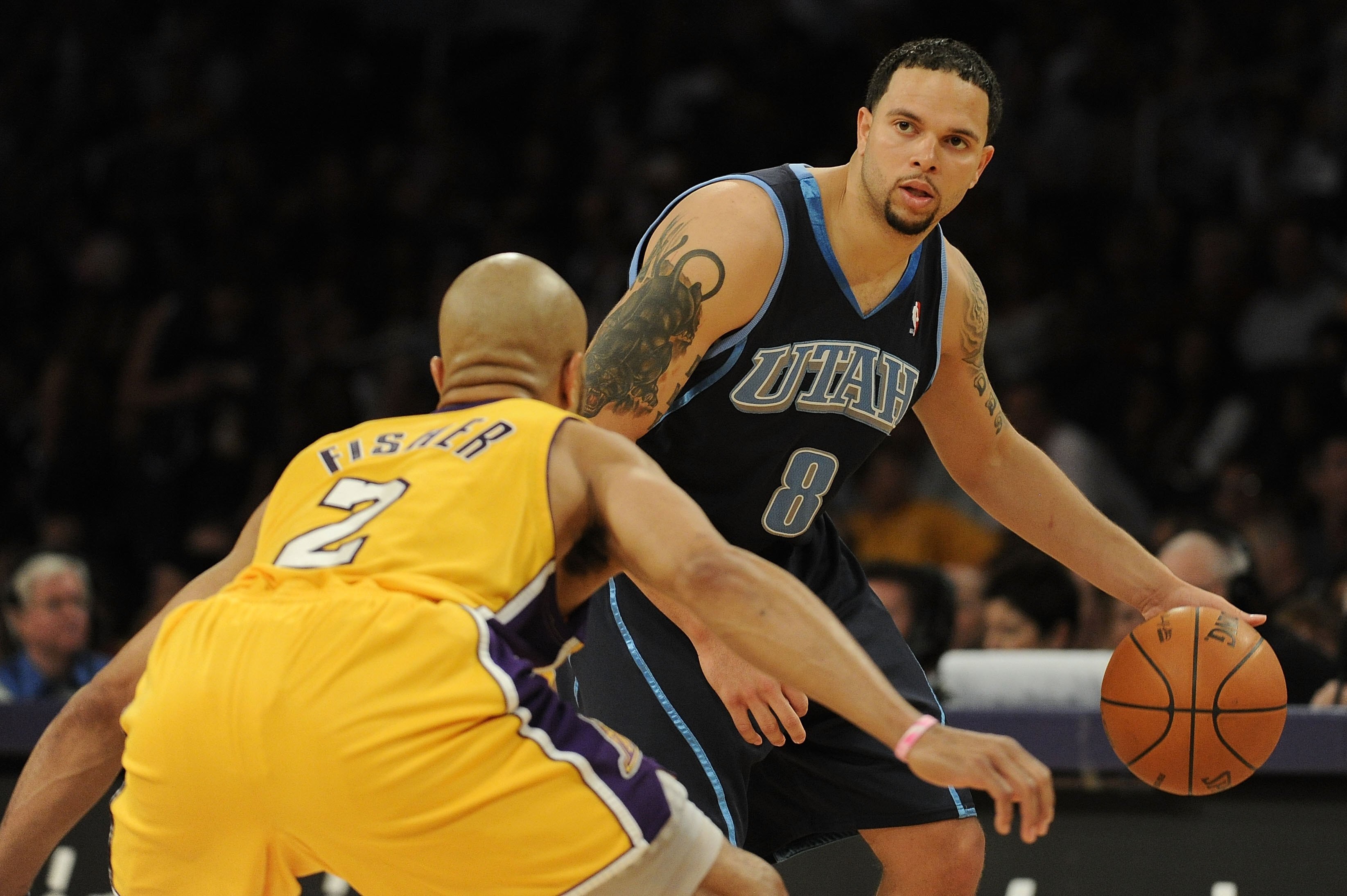 LOS ANGELES, CA - MAY 04:  Deron Williams #8 of the Utah Jazz moves the ball against Derek Fisher #2 of the Los Angeles Lakers during Game Two of the Western Conference Semifinals during the 2010 NBA Playoffs at Staples Center on May 4, 2010 in Los Angele