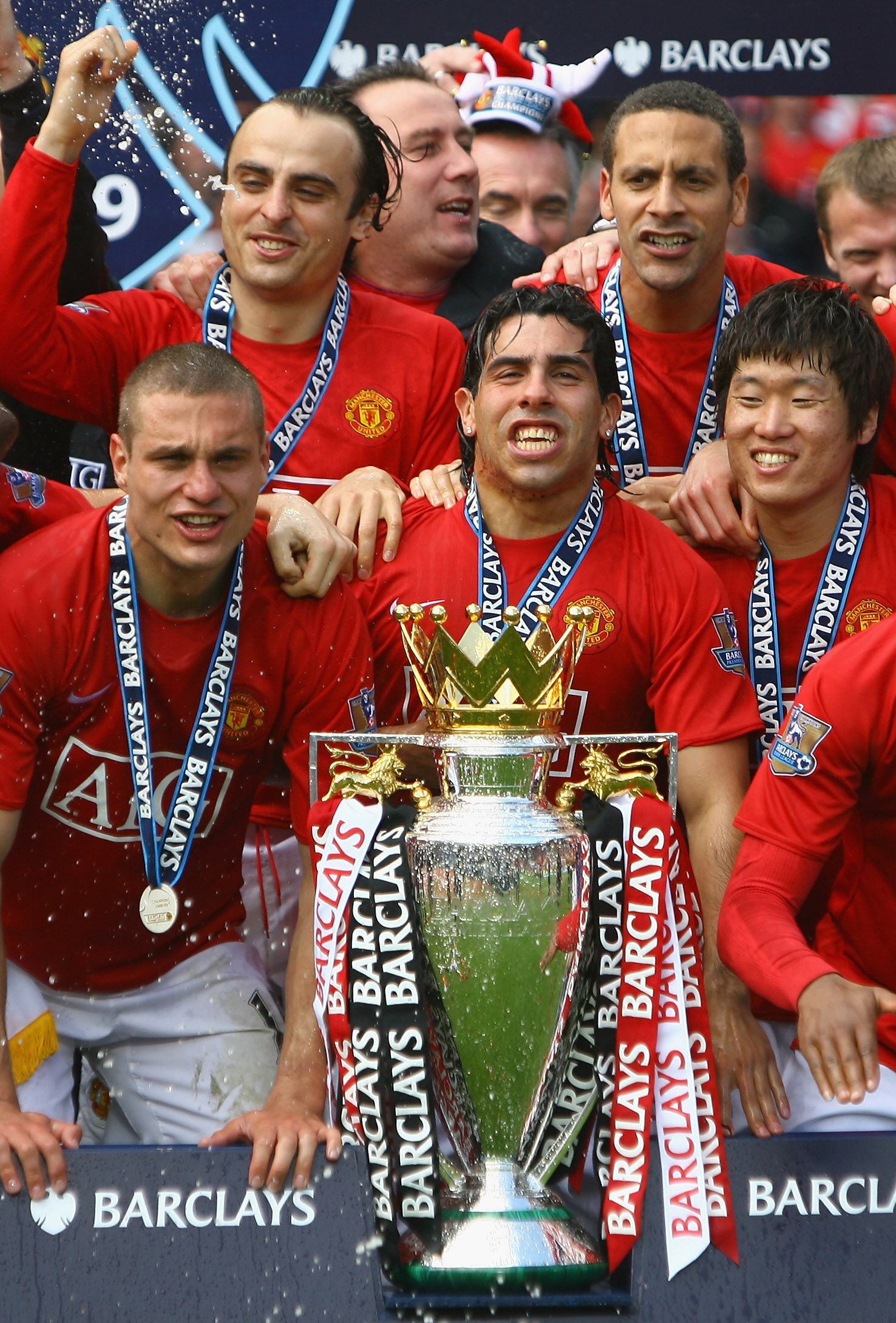 MANCHESTER, ENGLAND - MAY 16:  Carlos Tevez, Nemanja Vidic, Ji-Sung Park, Rio Ferdinand and Dimitar Berbatov of Manchester United celebrate winning the Barclays Premier League trophy after the Barclays Premier League match between Manchester United and Ar