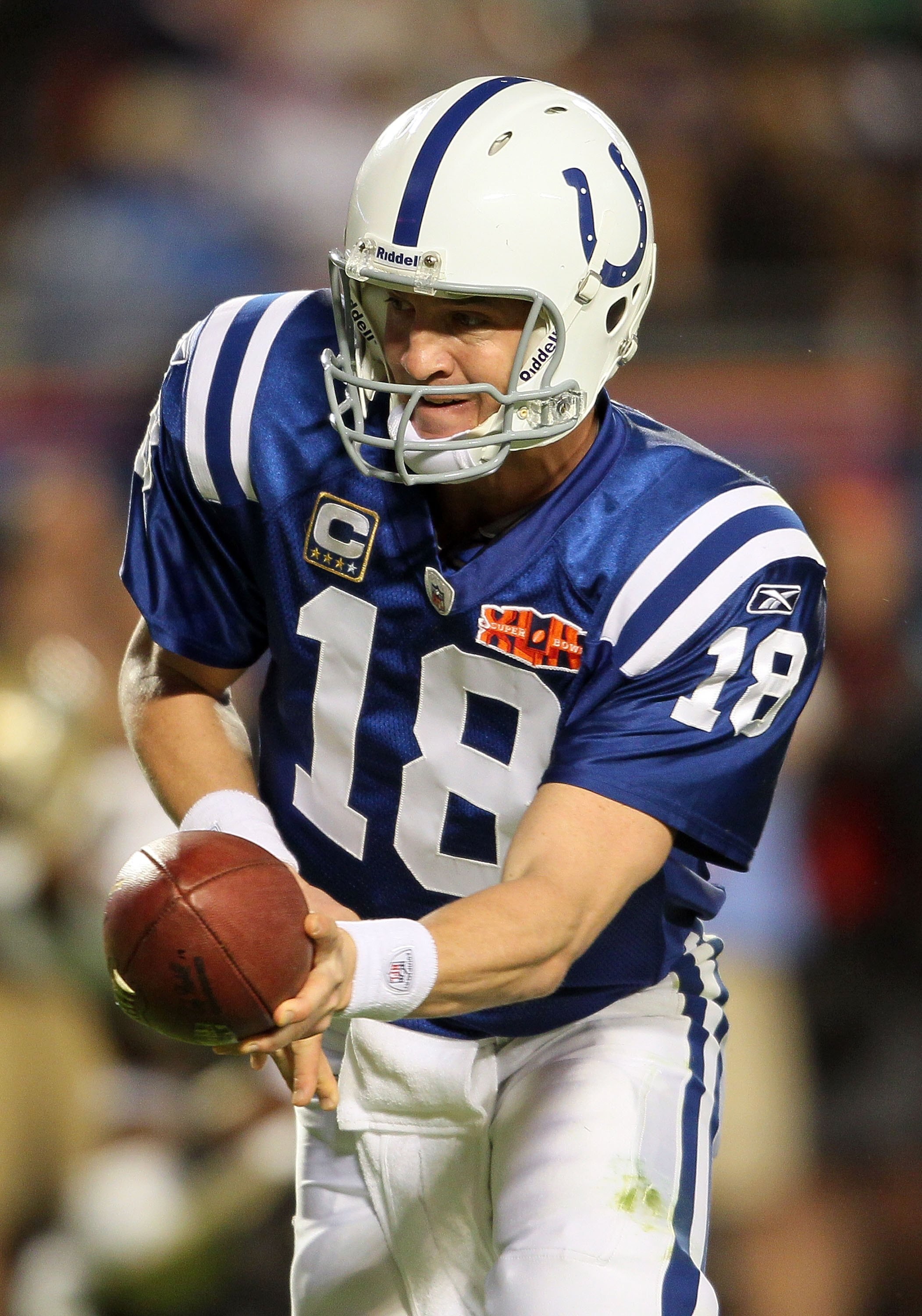 MIAMI GARDENS, FL - FEBRUARY 07:  Quarterback Peyton Manning #18 of the Indianapolis Colts hands off the ball against the New Orleans Saints during Super Bowl XLIV on February 7, 2010 at Sun Life Stadium in Miami Gardens, Florida.  (Photo by Andy Lyons/Ge
