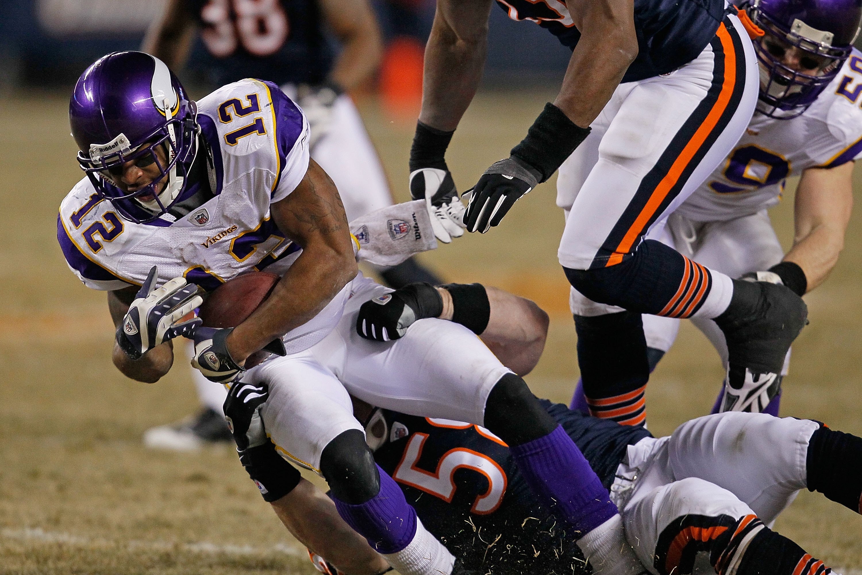 CHICAGO - DECEMBER 28: Percy Harvin #12 of the Minnesota Vikings is tackled by Tim Shaw #58 of the Chicago Bears at Soldier Field on December 28, 2009 in Chicago, Illinois. The Bears defeated the Vikings 36-30 in overtime.  (Photo by Jonathan Daniel/Getty