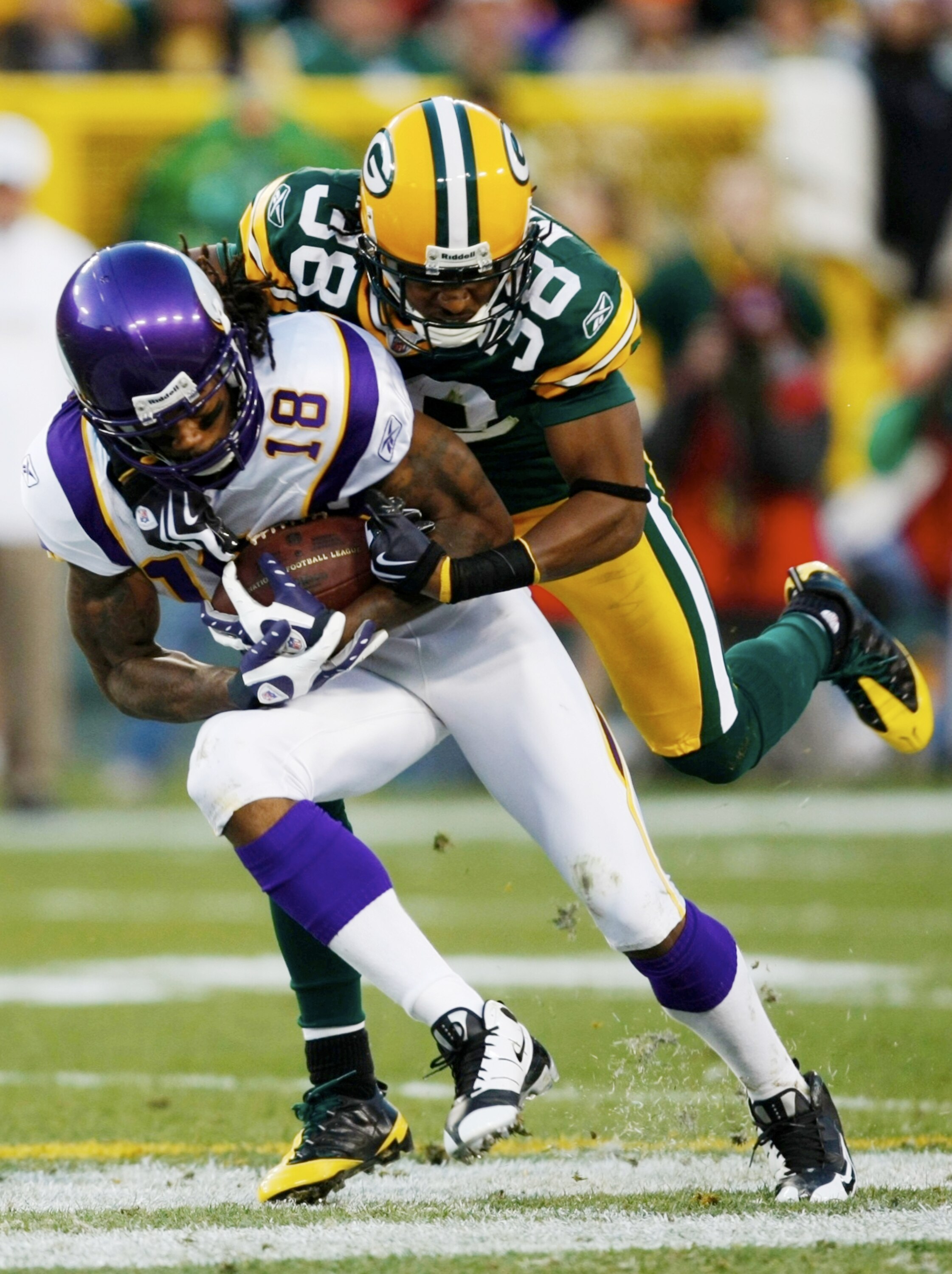 GREEN BAY, WI - NOVEMBER 01:  Tramon Williams #38 of the Green Bay Packers tackles Sidney Rice #18 of the Minnesota Vikings during the second quarter of the game at Lambeau Field on November 1, 2009 in Green Bay, Wisconsin. (Photo by Scott Boehm/Getty Ima