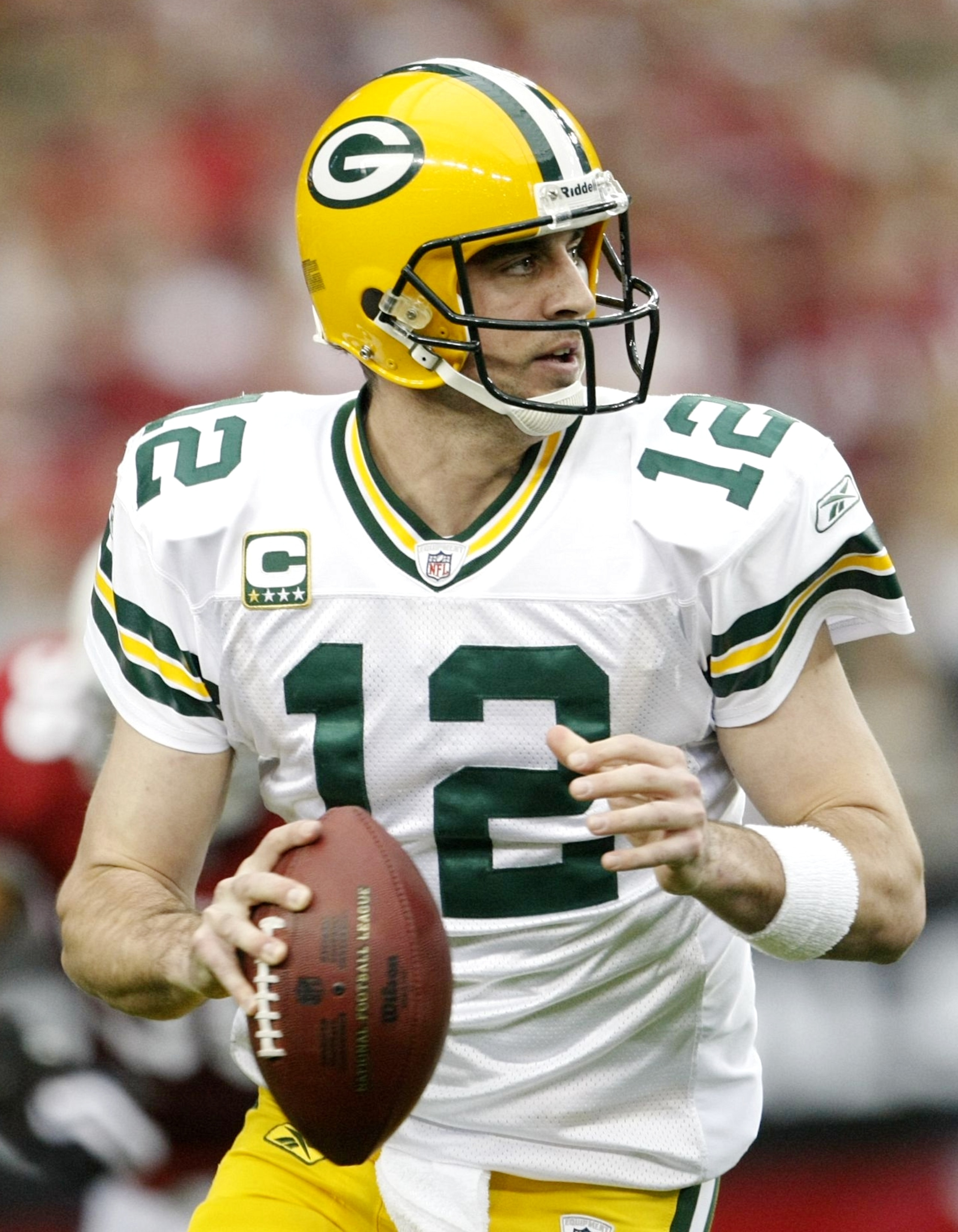 GLENDALE, AZ - JANUARY 10:  Quarterback Aaron Rodgers #12 of the Green Bay Packers drops back to pass against the Arizona Cardinals during the 2010 NFC wild-card playoff game at University of Phoenix Stadium on January 10, 2010 in Glendale, Arizona.   (Ph