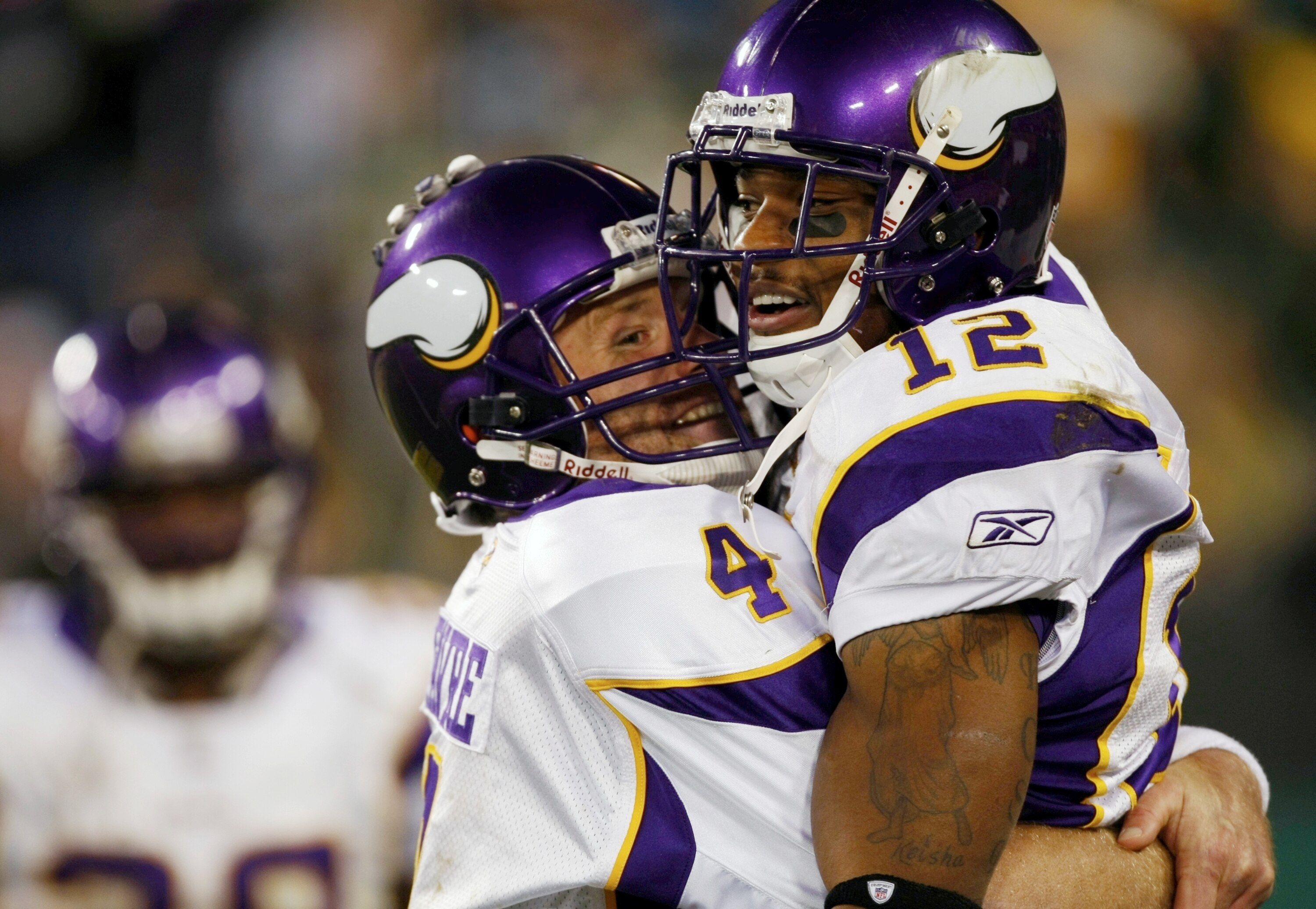 GREEN BAY, WI - NOVEMBER 01: Quarterback Brett Favre #4 of the Minnesota Vikings celebrates with teammate Percy Harvin #12 after a 51 yard touchdown pass during the third quarter of the game against the Green Bay Packers at Lambeau Field on November 1, 20