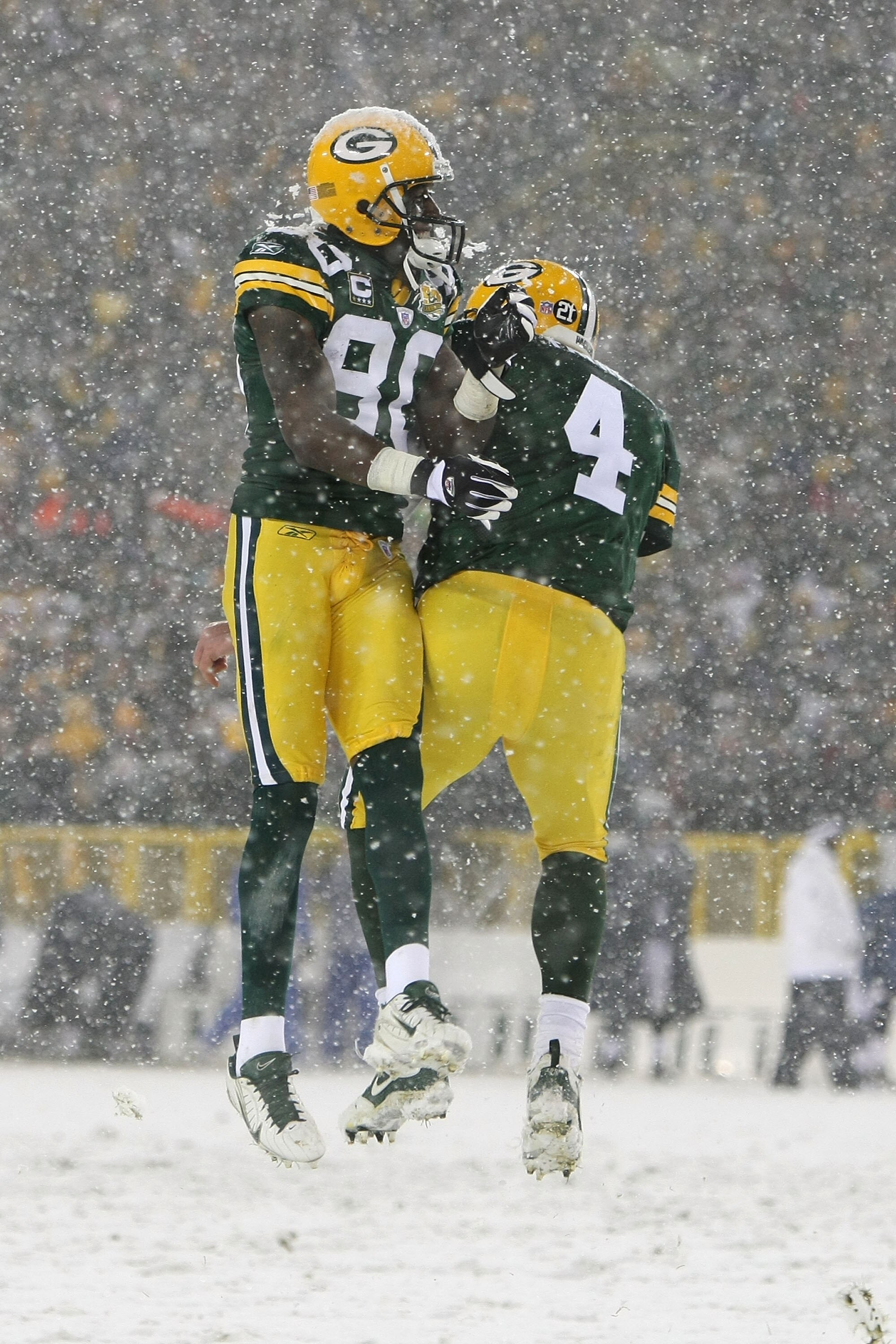 GREEN BAY, WI - JANUARY 12:  Wide receiver Donald Driver #80 and quarterback Brett Favre #4 of the Green Bay Packers celebrate after running back Ryan Grant #25 scored on a one-yard run in the fourth quarter against the Seattle Seahawks during the NFC div
