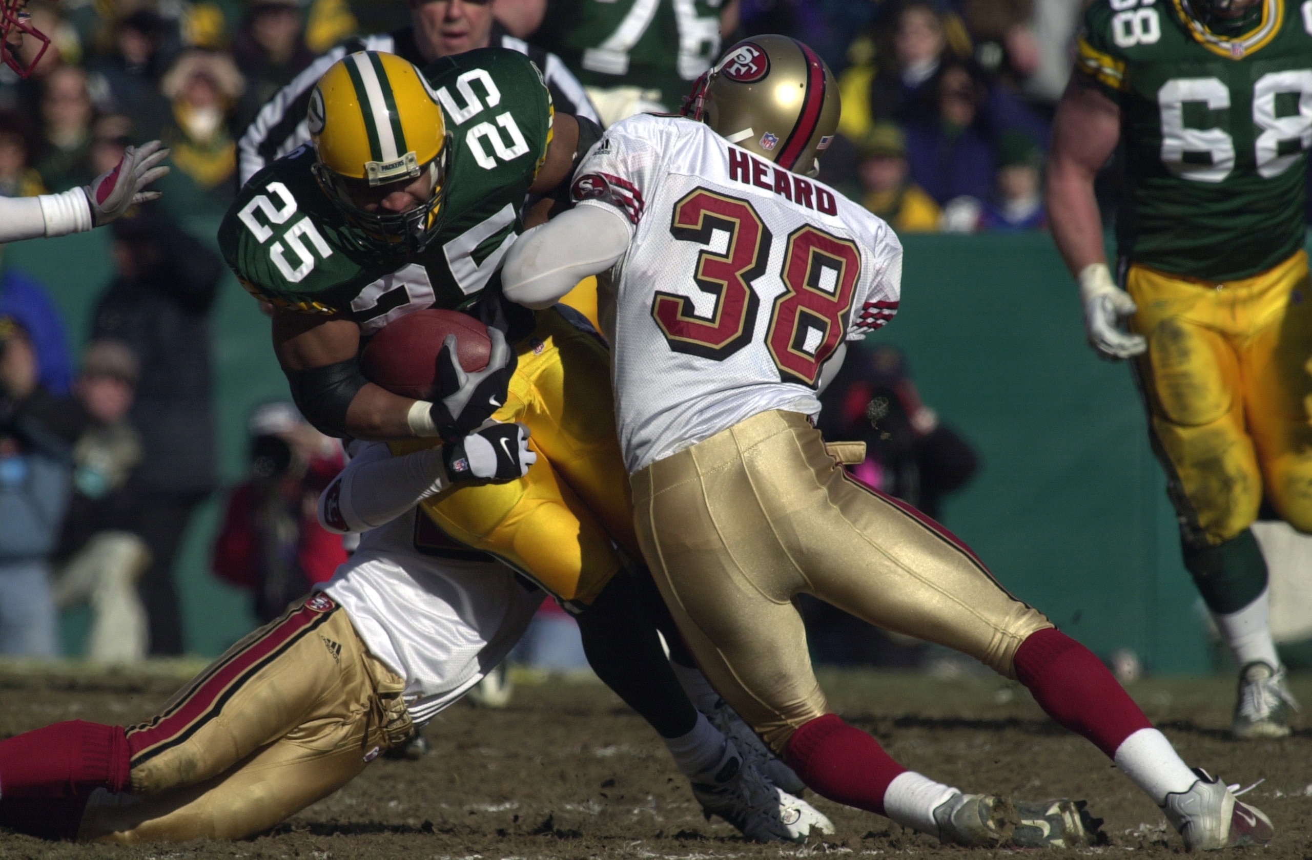 13 Jan 2002:  Dorsey Levens #25 of the Green Bay Packers is hit by Ronnie Heard #38 of the San Francisco 49ers  during the NFC wild-card game at Lambeau Field in Green Bay, Wisconsin. The Packers won 25-15. DIGITAL IMAGE Mandatory Credit: Jonathan Daniel/