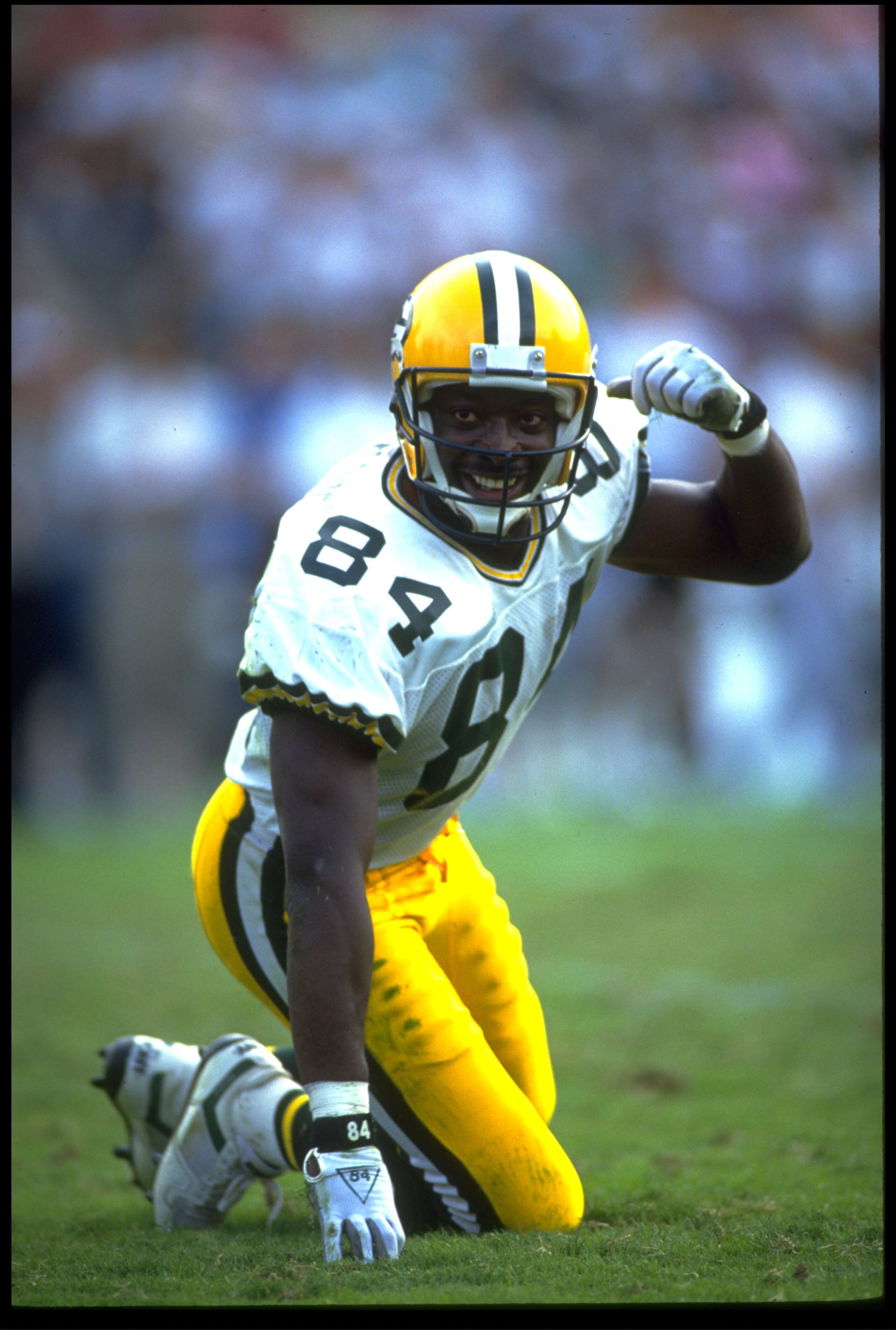 11 NOV 1990:  GREEN PACKERS WIDE RECEIVER STERLING SHARPE LOOKS BACK TO THE LINE OF SCRIMMAGE DURING THE PACKERS 29-16 VICTORY OVER THE LOS ANGELES RAIDERS AT THE LOS ANGELES MEMORIAL COLISEUM IN LOS ANGELES, CALIFORNIA.