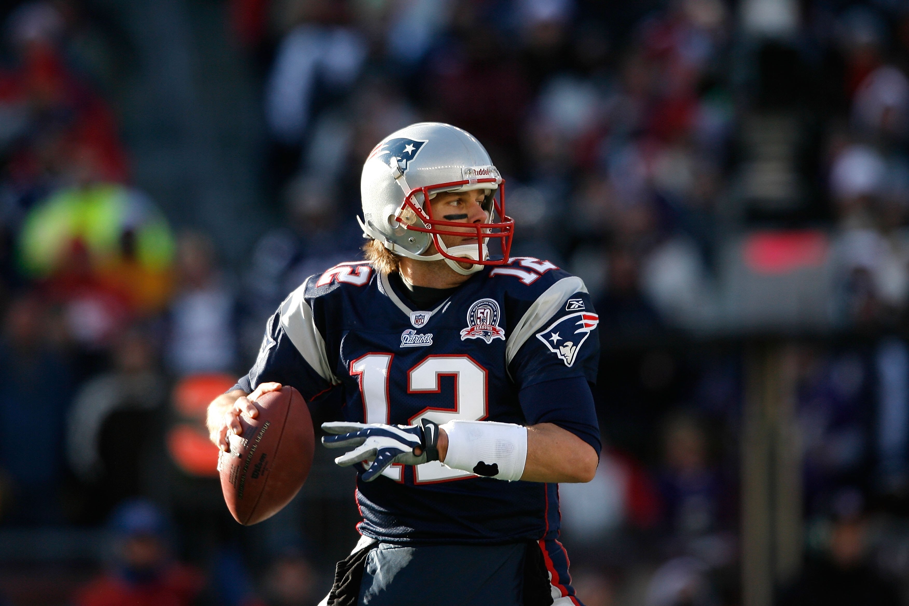 FOXBORO, MA - JANUARY 10:  Tom Brady #12 of the New England Patriots looks to pass against the Baltimore Ravens during the 2010 AFC wild-card playoff game at Gillette Stadium on January 10, 2010 in Foxboro, Massachusetts. The Ravens won 33-14. (Photo by E
