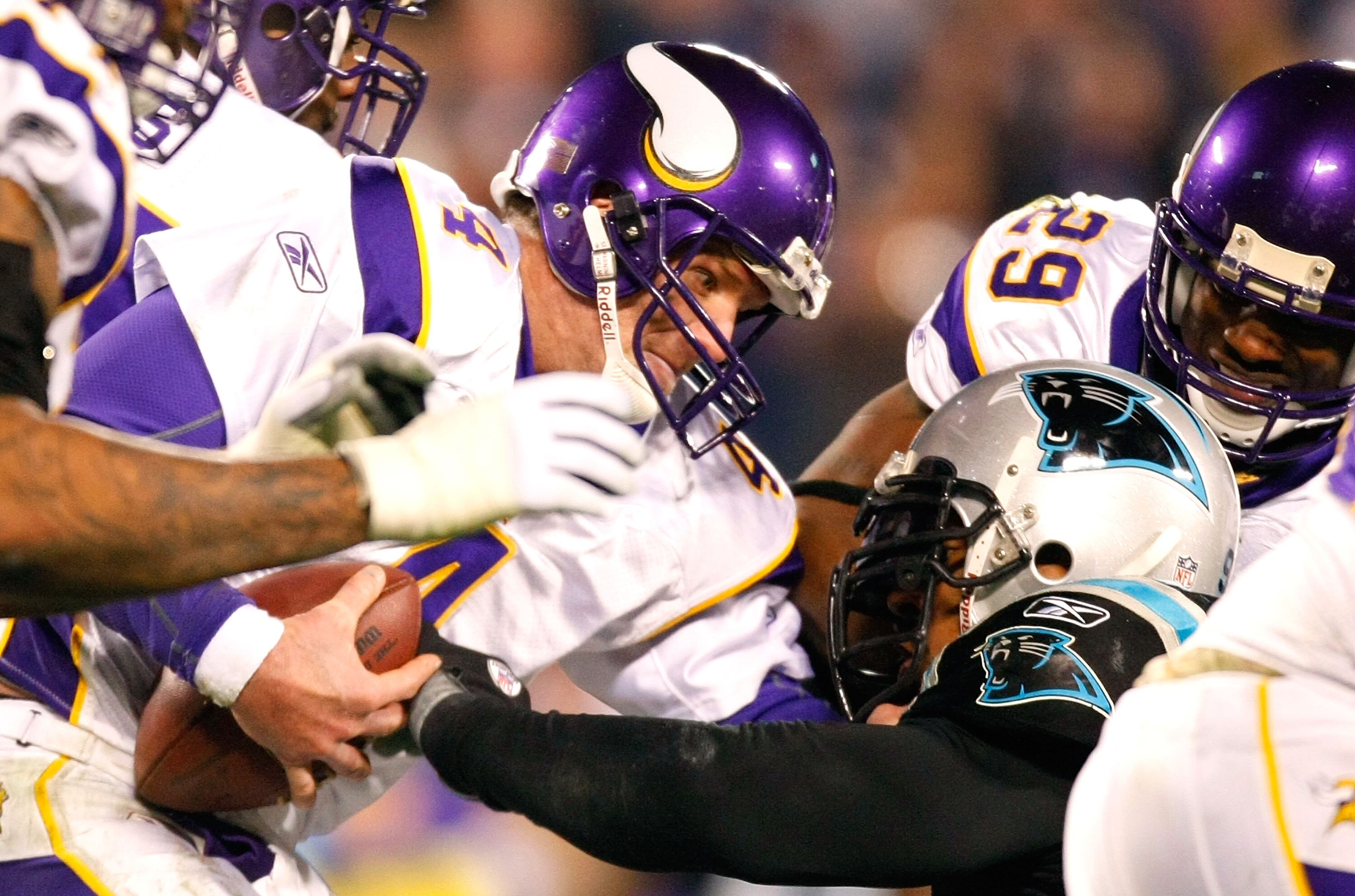 CHARLOTTE, NC - DECEMBER 20:  Quarterback Brett Favre #4 of the Minnesota Vikings escapes a sack by Julius Peppers #90 of the Carolina Panthers at Bank of America Stadium on December 20, 2009 in Charlotte, North Carolina.  (Photo by Kevin C. Cox/Getty Ima