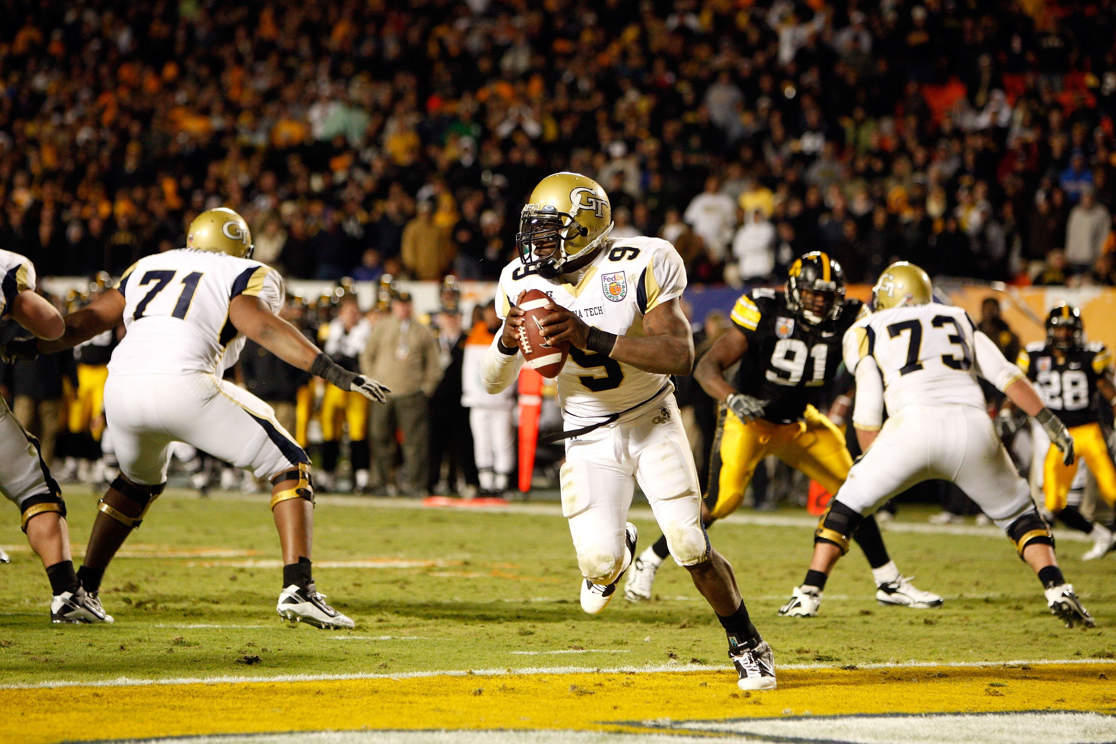 MIAMI GARDENS, FL - JANUARY 05:  Quarterback Josh Nesbitt of the Georgia Tech Yellow Jackets rolls out of the pocket against the Iowa Hawkeyes during the FedEx Orange Bowl at Land Shark Stadium on January 5, 2010 in Miami Gardens, Florida.  (Photo by Stre