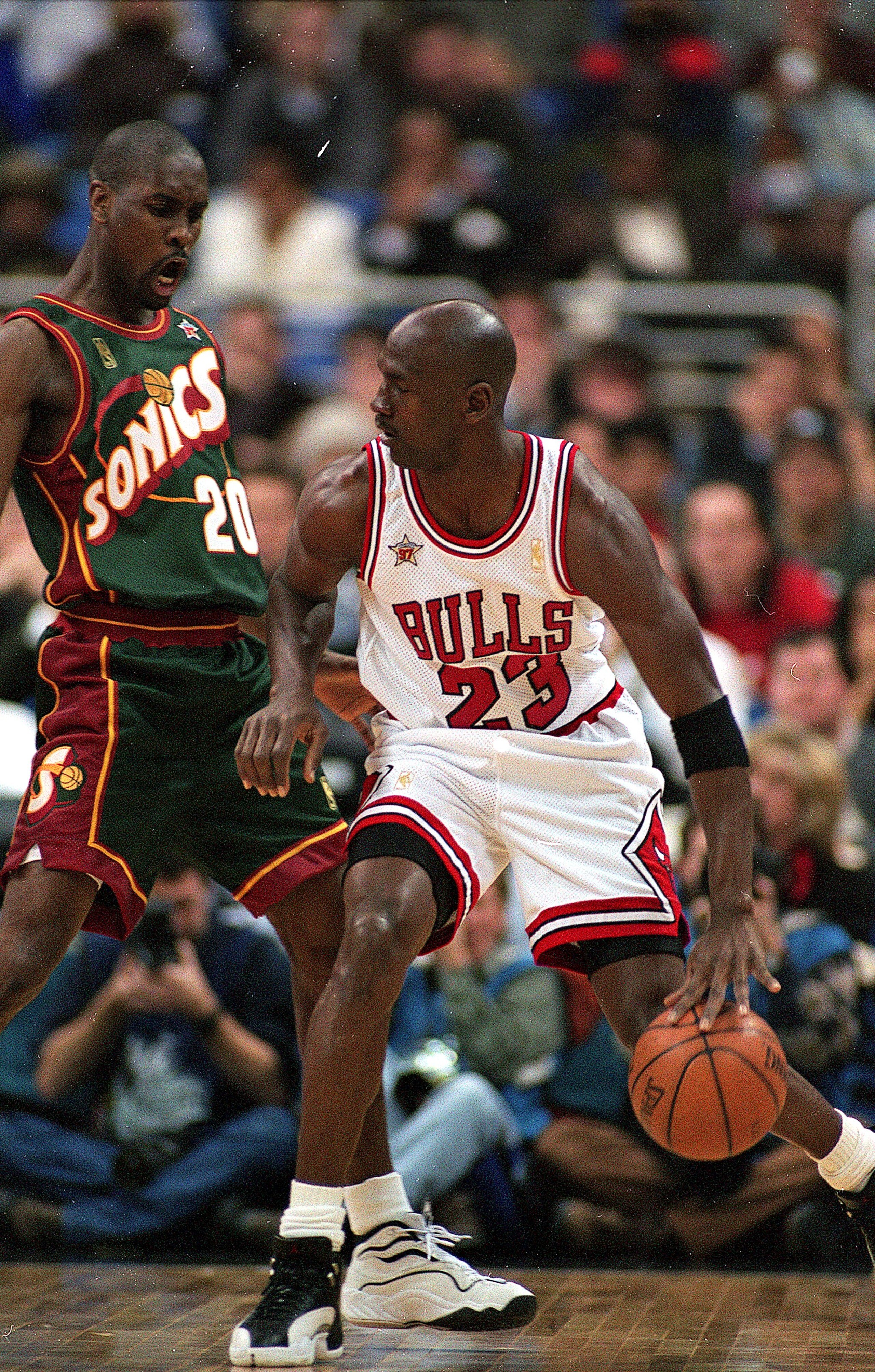 9 Feb 1997: Michael Jordan #23 of the Chicago Bulls dribbles the ball as he is guarded by Gary Payton #20 of Seattle SuperSonics during the NBA All-Star Game at the Gund Arena in Cleveland, Ohio.The East defeated the West 132-120 .
