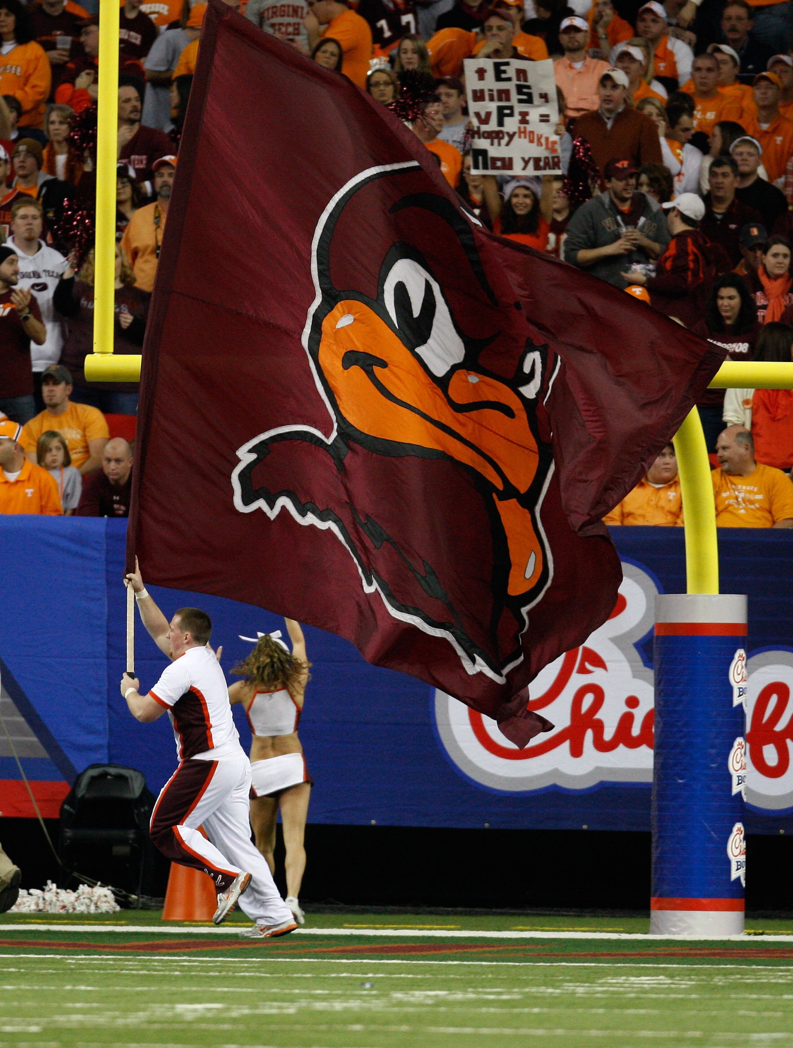 ATLANTA - DECEMBER 31:  A Virginia Tech Hokies cheerleader runs in the end zone with a flag after a Virginia Tech touchdown during the Chick-Fil-A Bowl during the Chick-Fil-A Bowl against the Tennessee Volunteers at the Georgia Dome on December 31, 2009 i