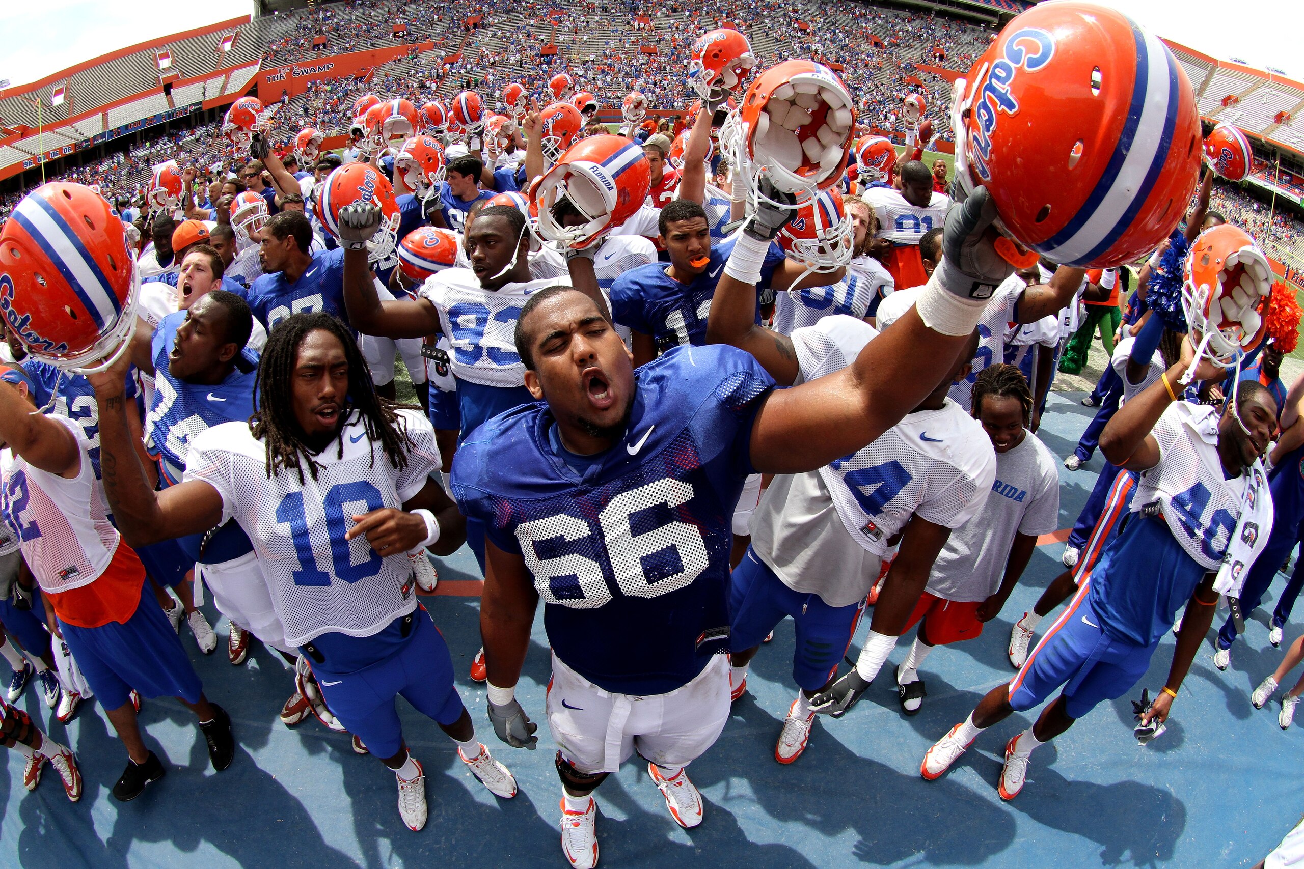 GAINESVILLE, FL - APRIL 10:  Safety Will Hill #10 and offensive lineman James Wilson #66 of the Florida Gators lead the team in the singing of the school fight song with fans after the Orange & Blue game at Ben Hill Griffin Stadium on April 10, 2010 in Ga