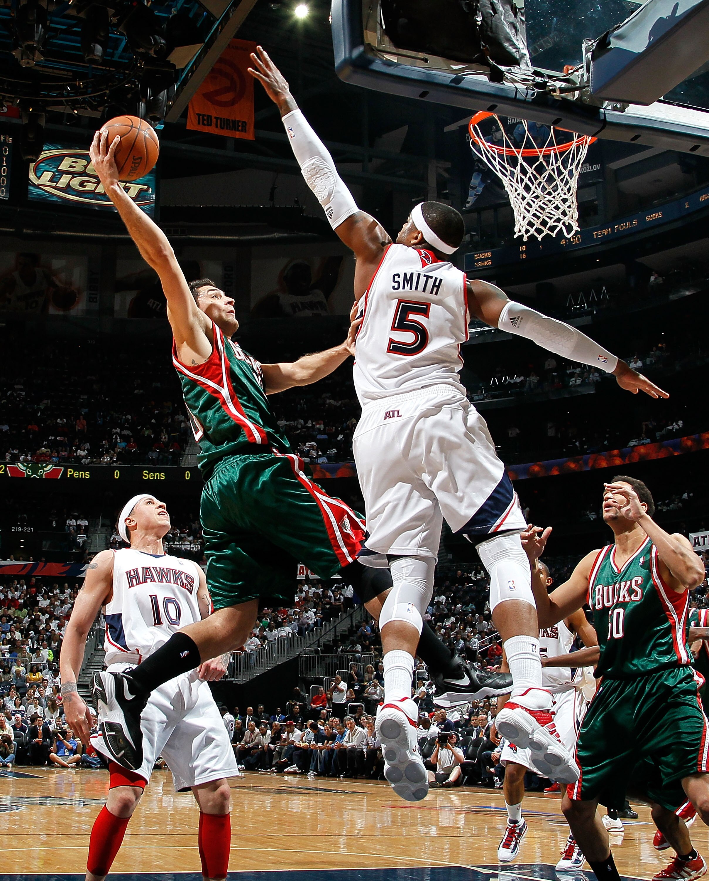 ATLANTA - APRIL 20:  Josh Smith #5 of the Atlanta Hawks defends the basket against Carlos Delfino #10 of the Milwaukee Bucks at Philips Arena on April 20, 2010 in Atlanta, Georgia.  NOTE TO USER: User expressly acknowledges and agrees that, by downloading