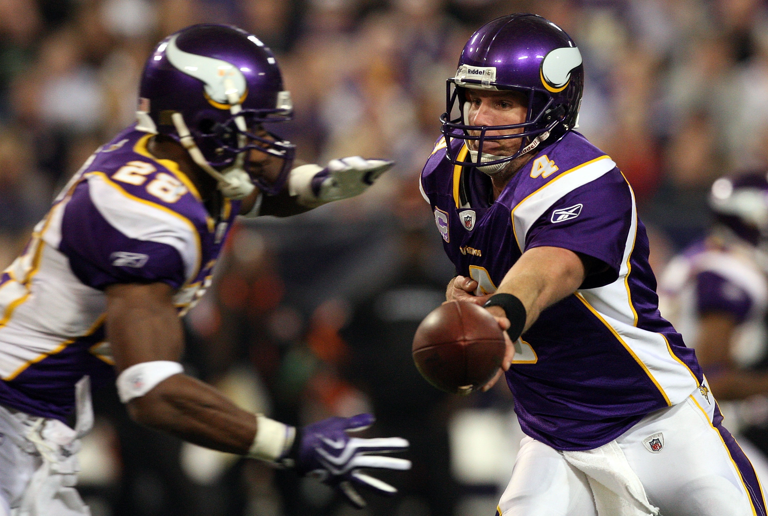 MINNEAPOLIS, MN - DECEMBER 13:  Brett Favre #4 of the Minnesota Vikings hands off the ball against the Cincinnati Bengals to teammate Adrian Peterson #28 on December 13, 2009 at Hubert H. Humphrey Metrodome in Minneapolis, Minnesota. The Vikings defeated 