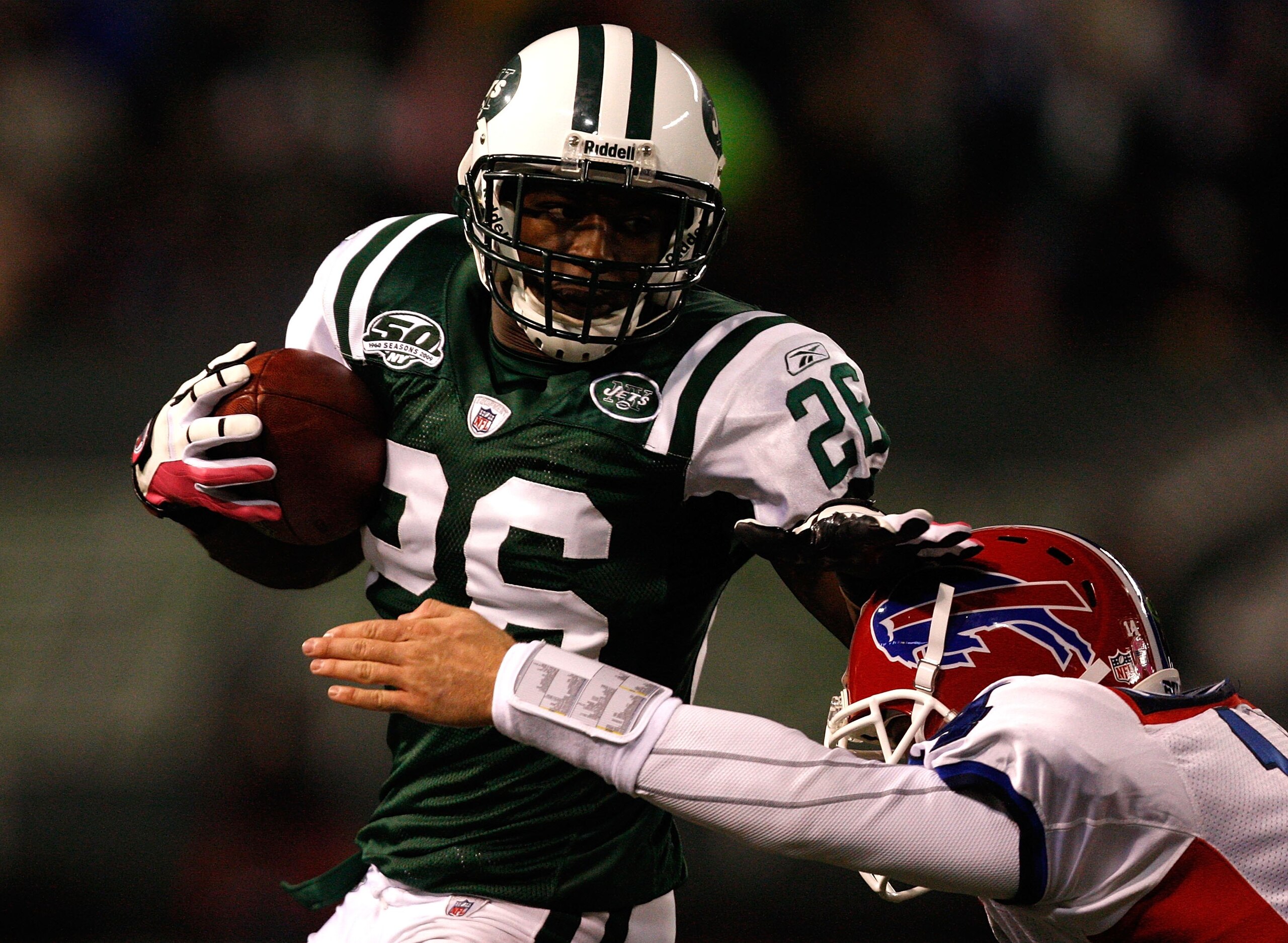 EAST RUTHERFORD, NJ - OCTOBER 18: Lito Sheppard #26 of the New York Jets evades a tackle by Ryan Fitzpatrick #14 of the Buffalo Bills after intercepting Fitzpatrick's pass during the game on October 18, 2009 at Giants Stadium in East Rutherford, New Jerse