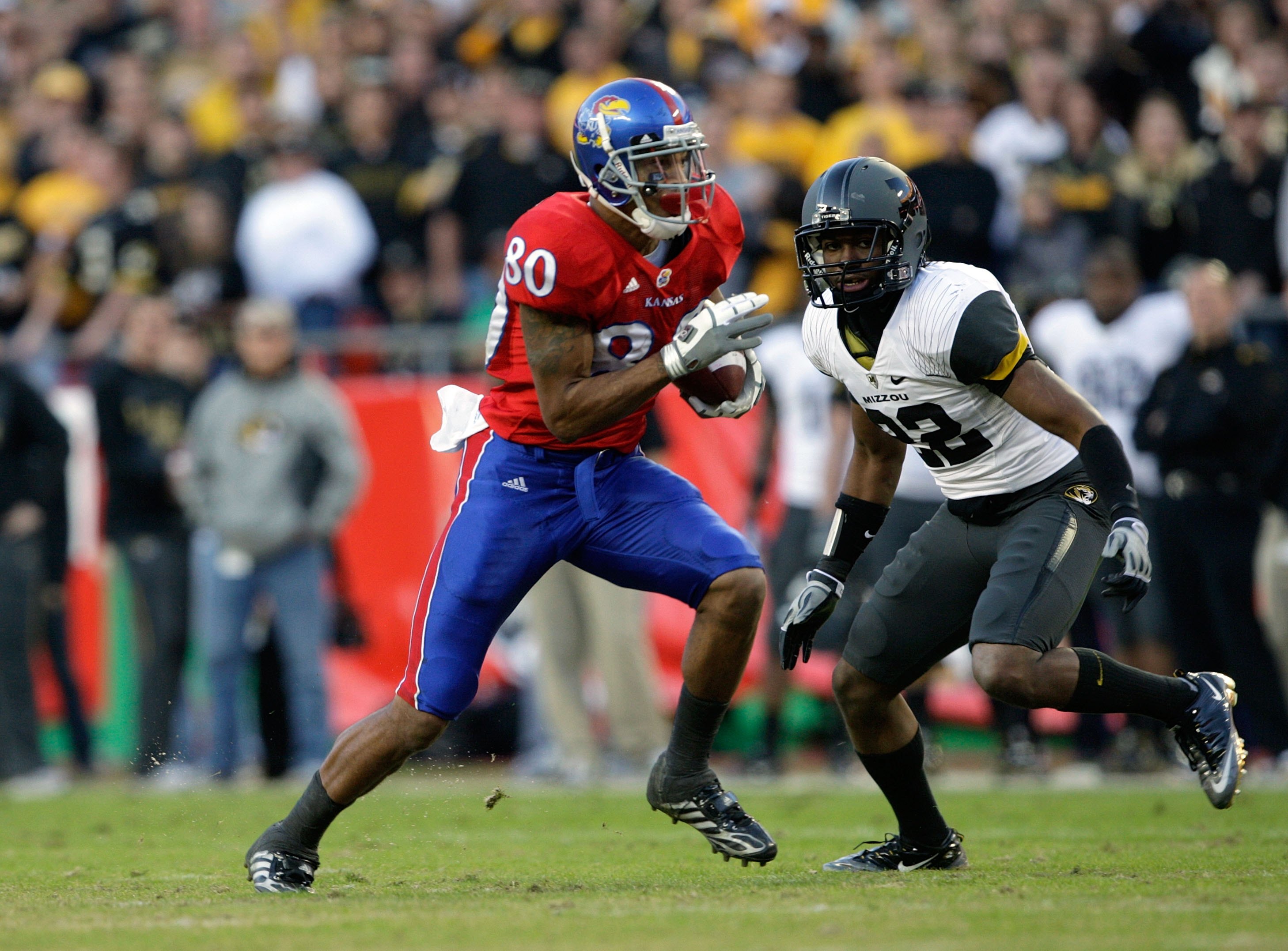 KANSAS CITY, MO - NOVEMBER 28:  Dezmon Briscoe #80 of the Kansas Jayhawks runs with the ball for yardage during their game against the Missouri Tigers during the game at Arrowhead Stadium on November 28, 2009 in Kansas City, Missouri. (Photo by Jamie Squi