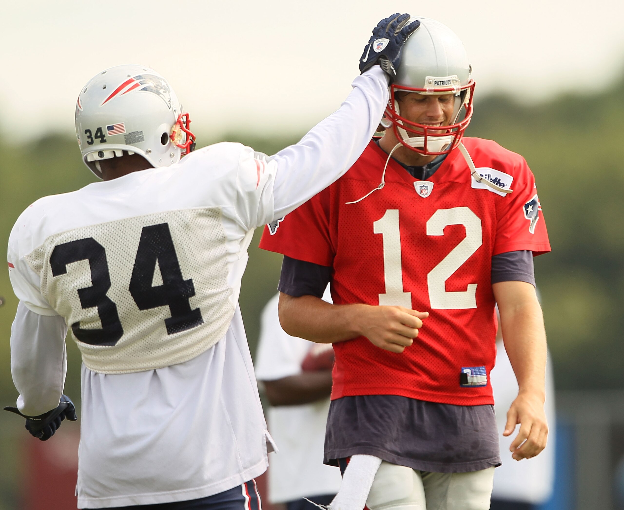 FOXBORO, MA - AUGUST 02:  Sammy Morris #34 of the New England Patriots greets Tom Brady #12 during training camp on August 2, 2010 at Gillette Stadium in Foxboro, Massachusetts.  (Photo by Elsa/Getty Images)