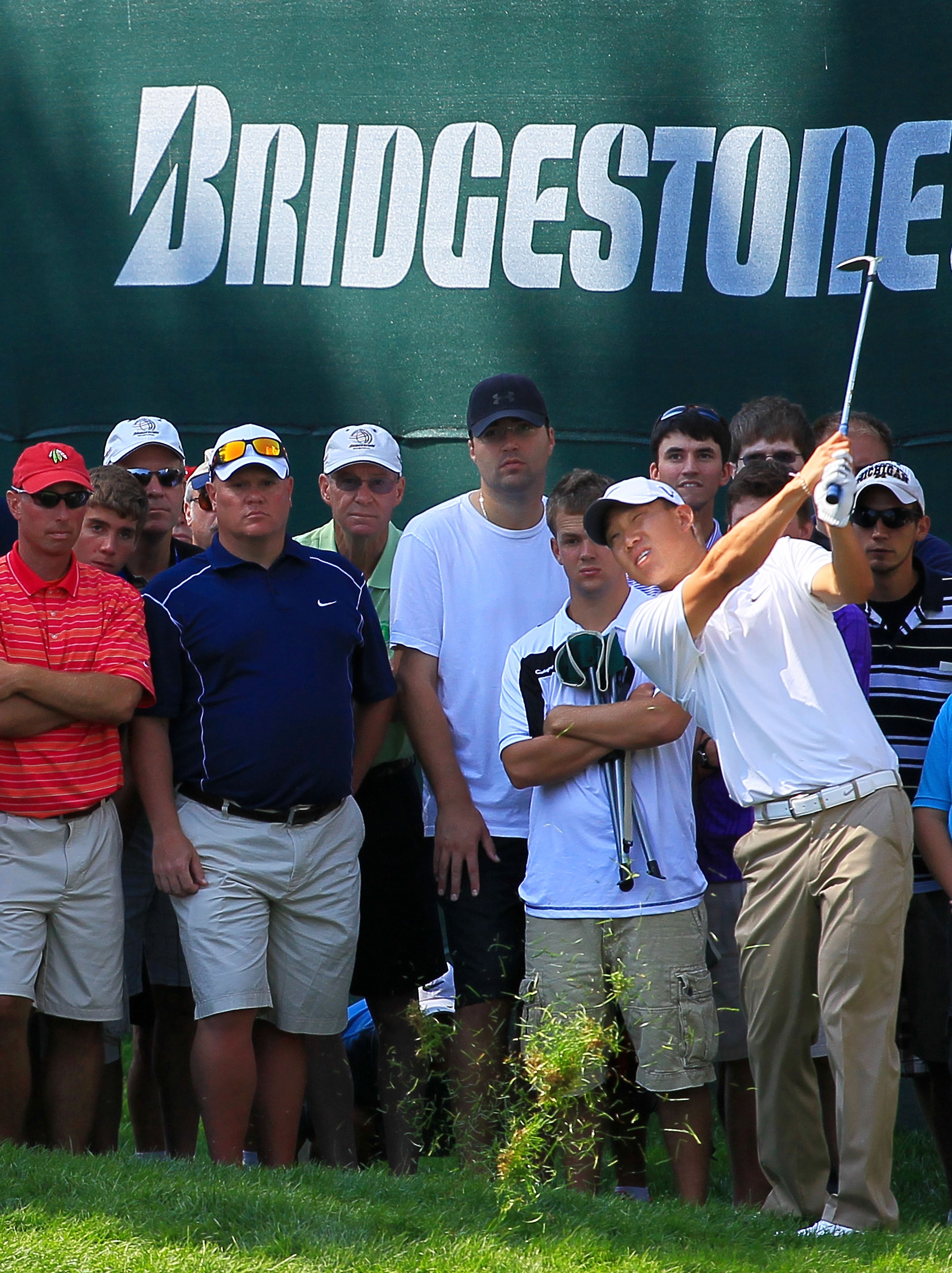 AKRON, OH - AUGUST 08:  Anthony Kim plays a shot from the rough on the 18th hole in front of a gallery of patrons during the final round of the World Golf Championships - Bridgestone Invitational on the South Course at Firestone Country Club on August 8, 
