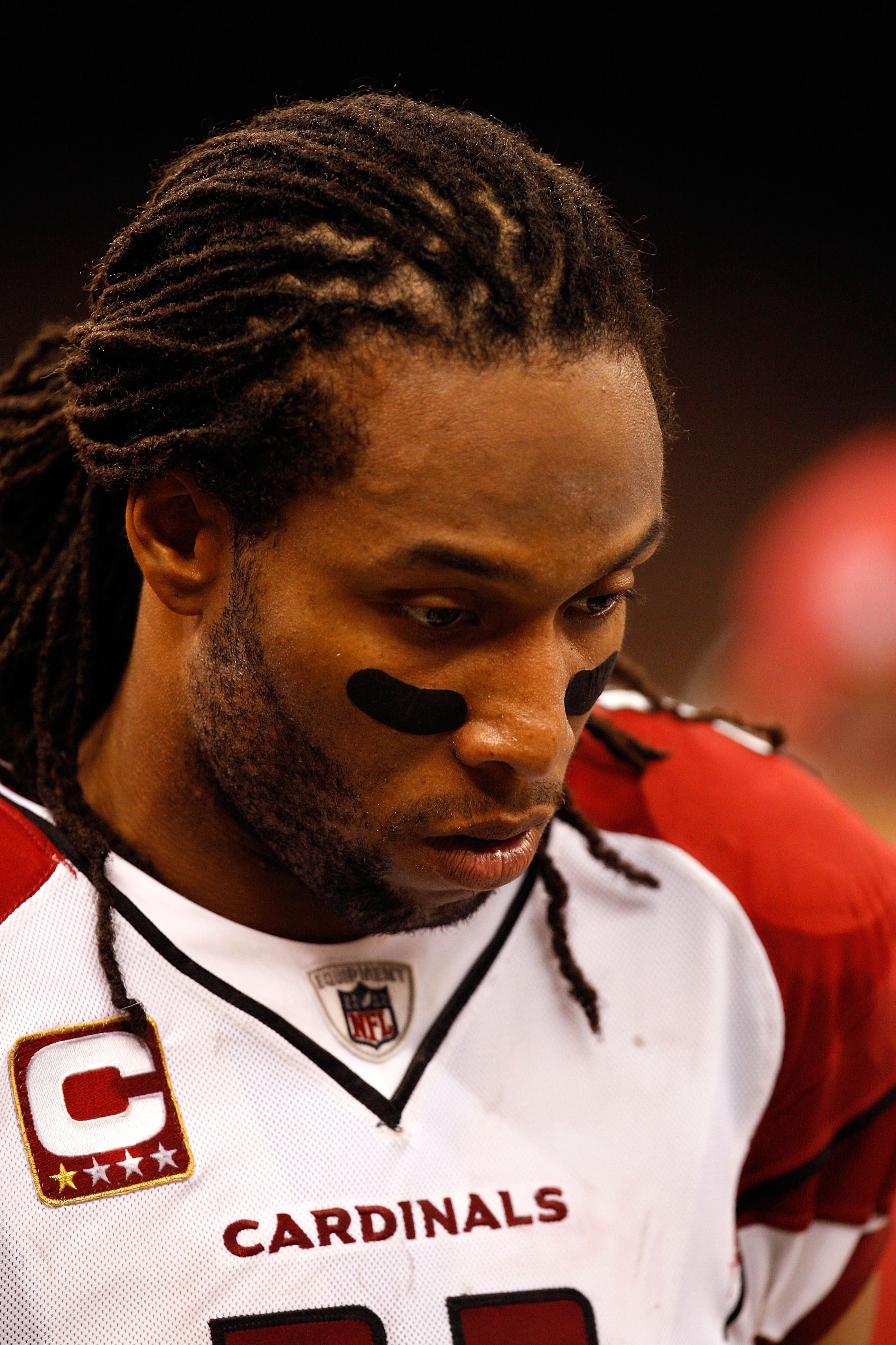 NEW ORLEANS - JANUARY 16:  Larry Fitzgerald #11 of the Arizona Cardinals stands on the sideline with his head down against the New Orleans Saints during the NFC Divisional Playoff Game at Louisana Superdome on January 16, 2010 in New Orleans, Louisiana. T