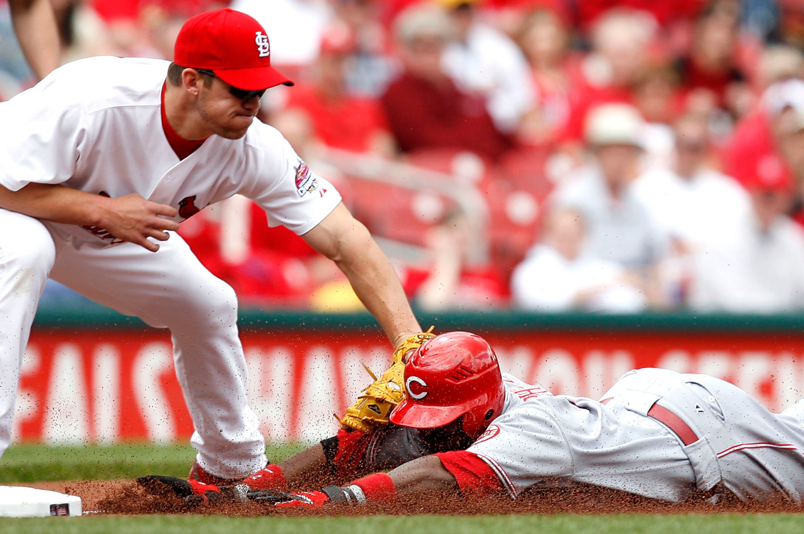 ST. LOUIS, MO - APRIL 26:  Scott Rolen #27 of the St. Louis Cardinals tags out Brandon Phillips #4 of the Cincinnati Reds on April 26, 2007 at Busch Stadium in St. Louis, Missouri.  The Cards beat the Reds 7-5.  (Photo by Dilip Vishwanat/Getty Images)