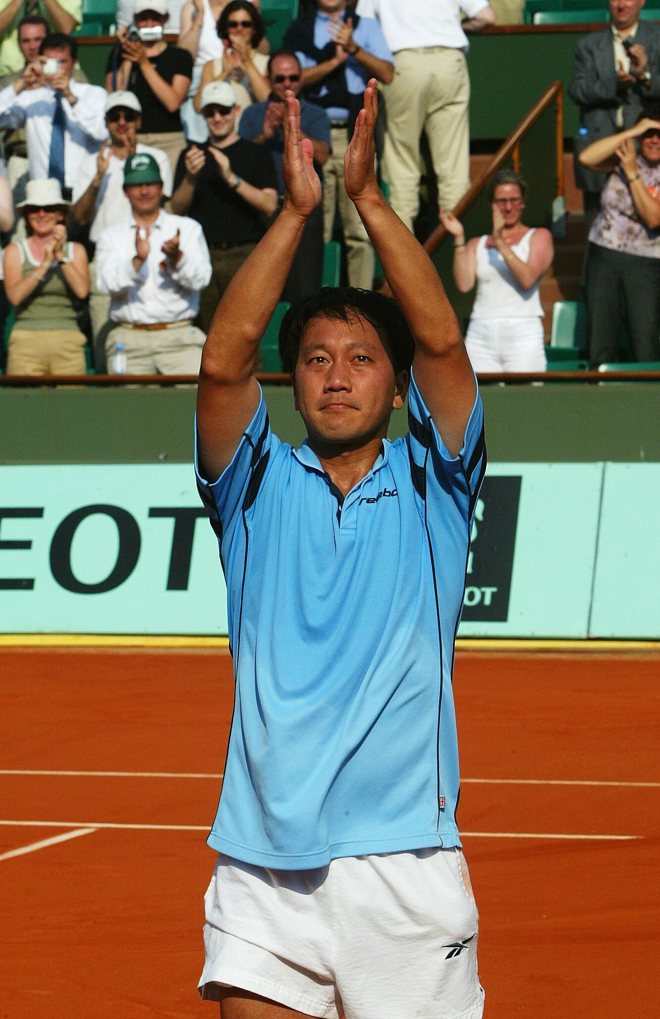 PARIS, FRANCE - MAY 27:  Michael Chang of the USA salutes the crowd after losing his first round match against Fabrice Santoro of France during the second day of the French Open on May 27, 2003 at Roland Garros in Paris, France. (Photo by Pascal Le Segret
