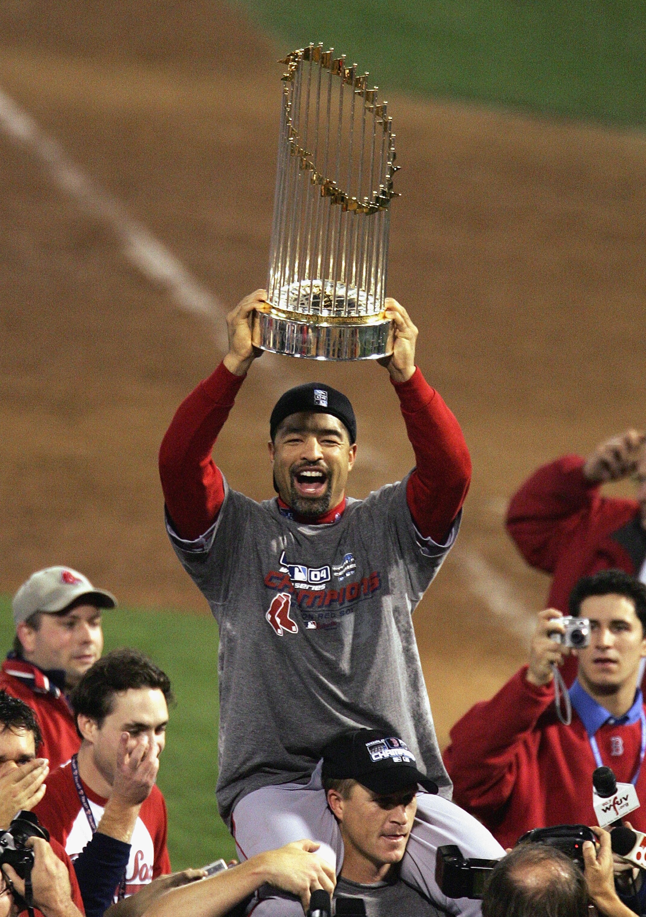 ST LOUIS - OCTOBER 27:  Dave Roberts #31 of the Boston Red Sox celebrates with the trophy over his head as he rides on the shoulders of teammate Mike Timlin #50 following the victory over the St. Louis Cardinals in game four of the World Series on October