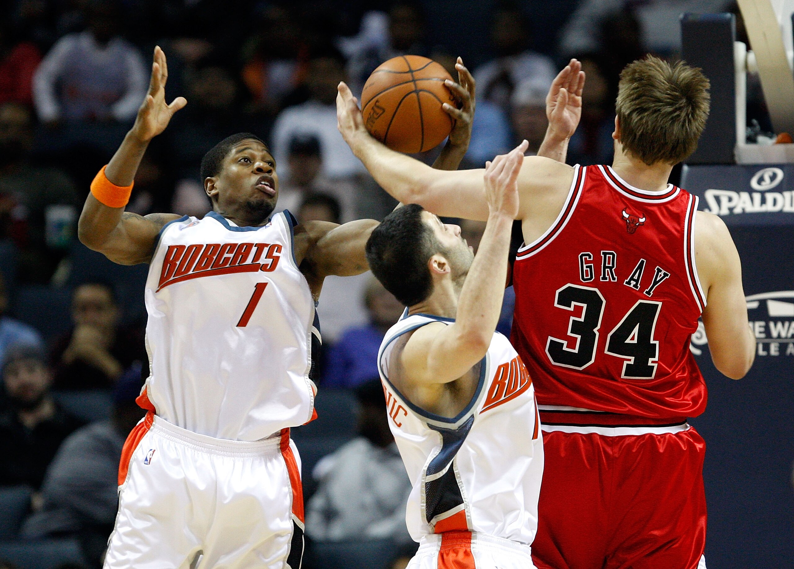 CHARLOTTE, NC - MARCH 03: Aaron Gray #34 of the Chicago Bulls battles for a loose ball with Cartier Martin #1 and Vladimir Radmanovic #10 of the Charlotte Bobcats during their game at Time Warner Cable Arena on March 3, 2009 in Charlotte, North Carolina. CHARLOTTE, NC - MARCH 03: Aaron Gray #34 of the Chicago Bulls battles for a loose ball with Cartier Martin #1 and Vladimir Radmanovic #10 of the Charlotte Bobcats during their game at Time Warner Cable Arena on March 3, 2009 in Charlotte, North Carolina.