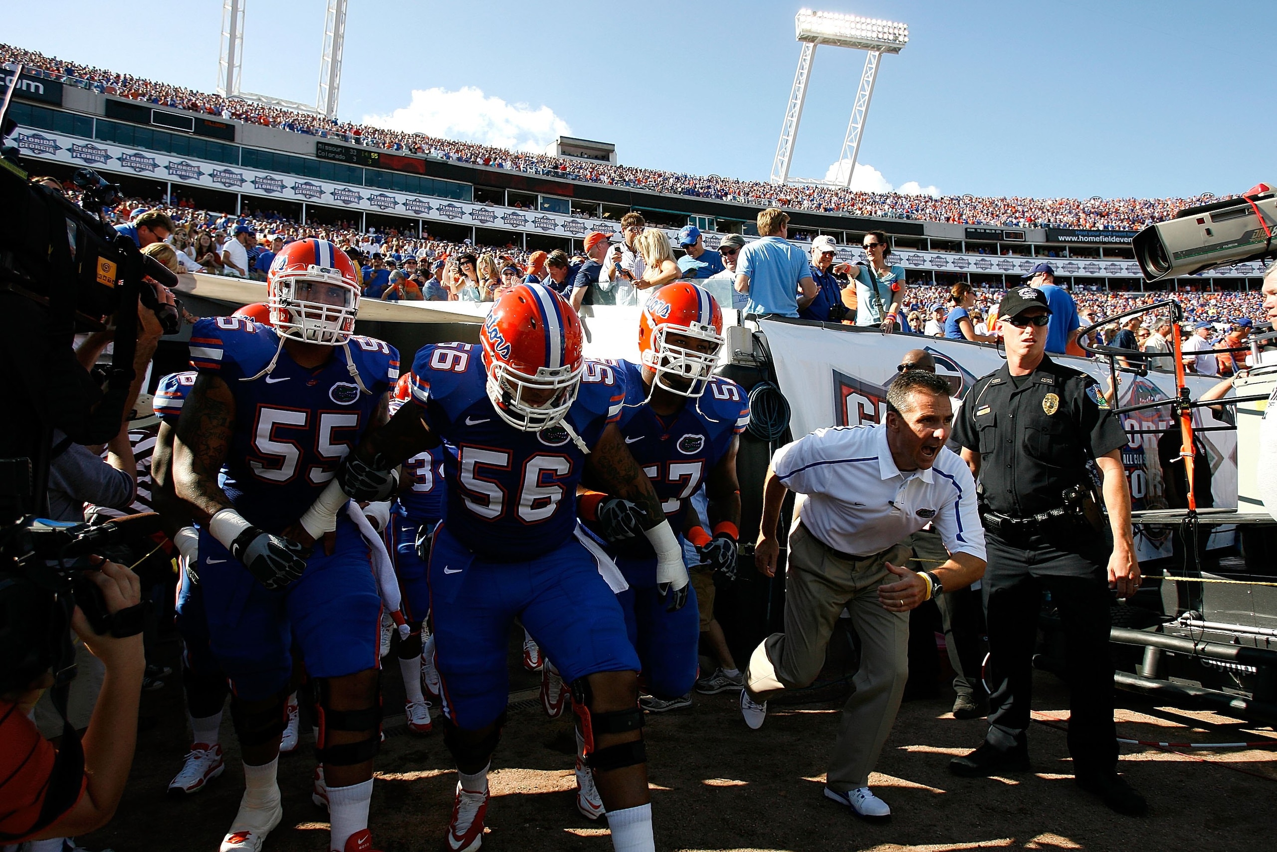 JACKSONVILLE, FL - OCTOBER 31:  Head coach Urban Meyer (R) of the Florida Gators leads his team onto the field to face the Georgia Bulldogs at Jacksonville Municipal Stadium on October 31, 2009 in Jacksonville, Florida.  (Photo by Kevin C. Cox/Getty Image