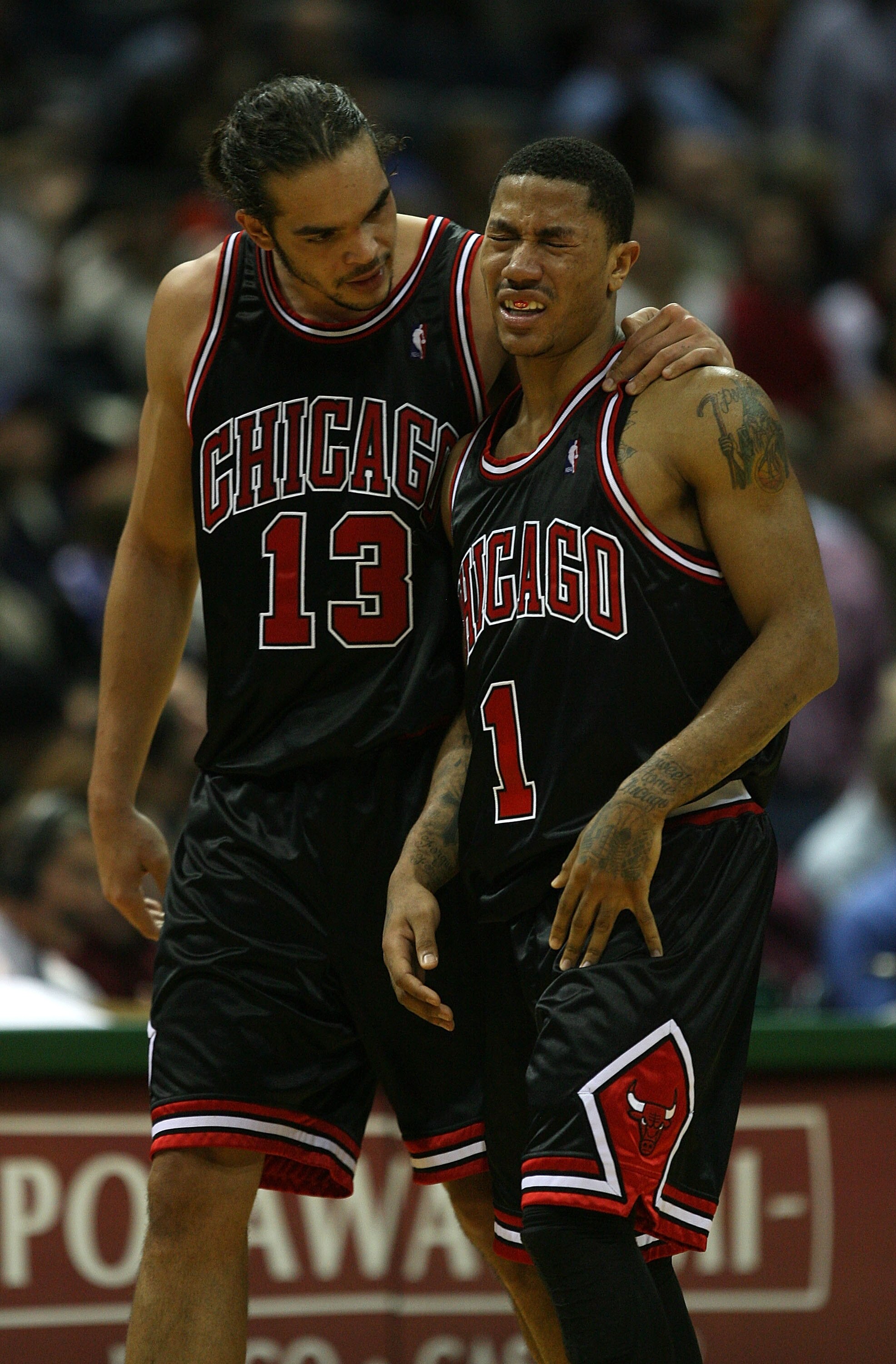 MILWAUKEE - NOVEMBER 30: Joakim Noah #13 of the Chicago Bulls consoles teammate Derrick Rose #1 during a time-out after Rose was fouled during a game against the Milwaukee Bucks at the Bradley Center on November 30, 2009 in Milwaukee, Wisconsin. The Bucks