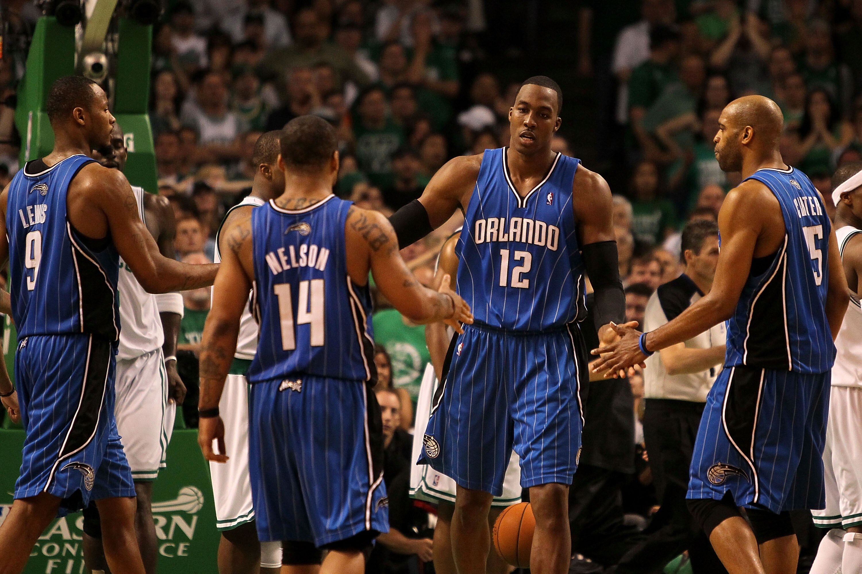 BOSTON - MAY 24:  Dwight Howard #12 of the Orlando Magic celebrates with Rashard Lewis #9, Jameer Nelson #14 and Vince Carter #15 after he made a basket in overtime the Boston Celtics in Game Four of the Eastern Conference Finals during the 2010 NBA Playo