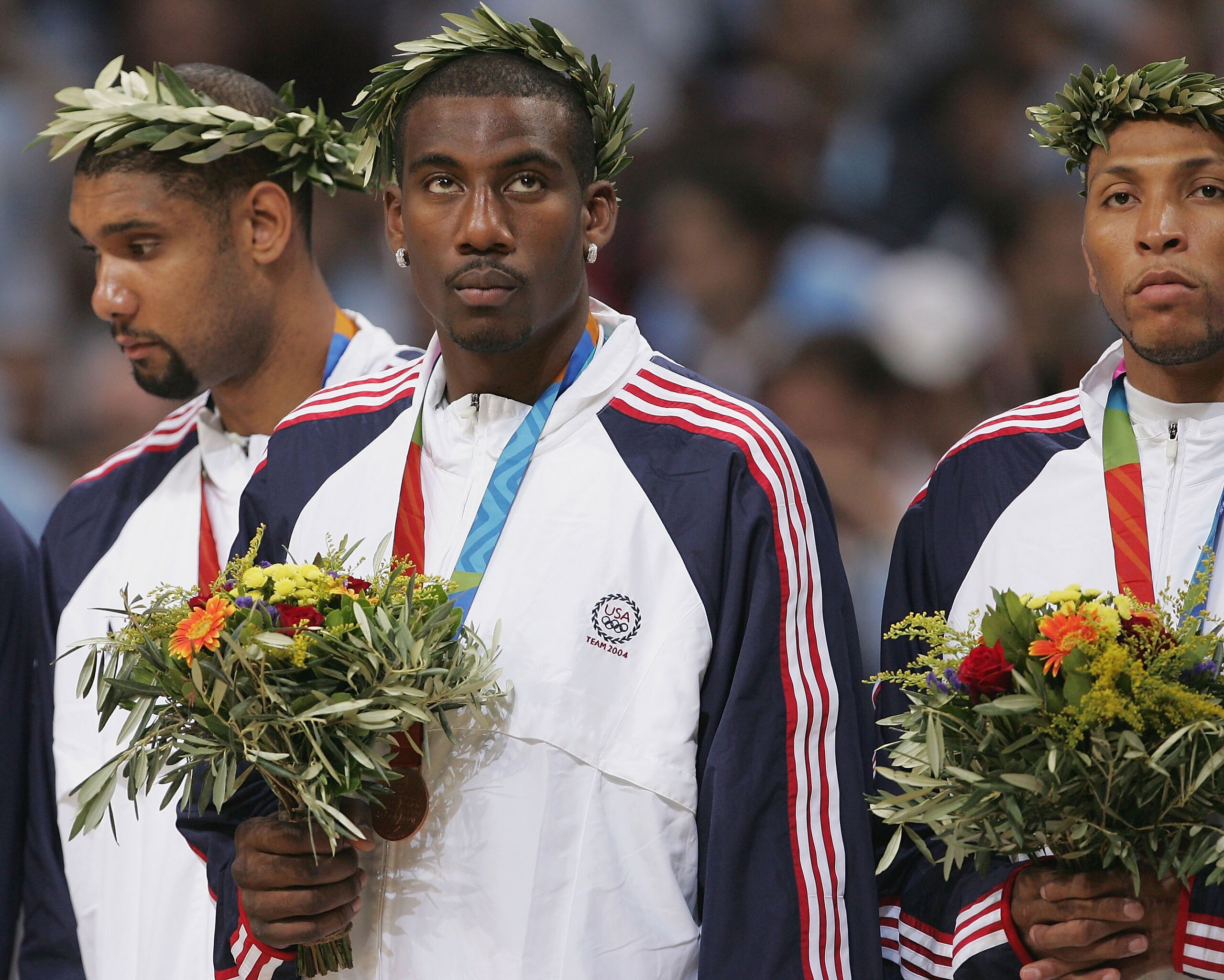 ATHENS - AUGUST 28: Amare Stoudemire #12 (C), Tim Duncan #13 (L) and Shawn Marion #11 of the United States receive the bronze medal for men's basketball during ceremonies on August 28, 2004 during the Athens 2004 Summer Olympic Games at the Indoor Hall o ATHENS - AUGUST 28: Amare Stoudemire #12 (C), Tim Duncan #13 (L) and Shawn Marion #11 of the United States receive the bronze medal for men's basketball during ceremonies on August 28, 2004 during the Athens 2004 Summer Olympic Games at the Indoor Hall o