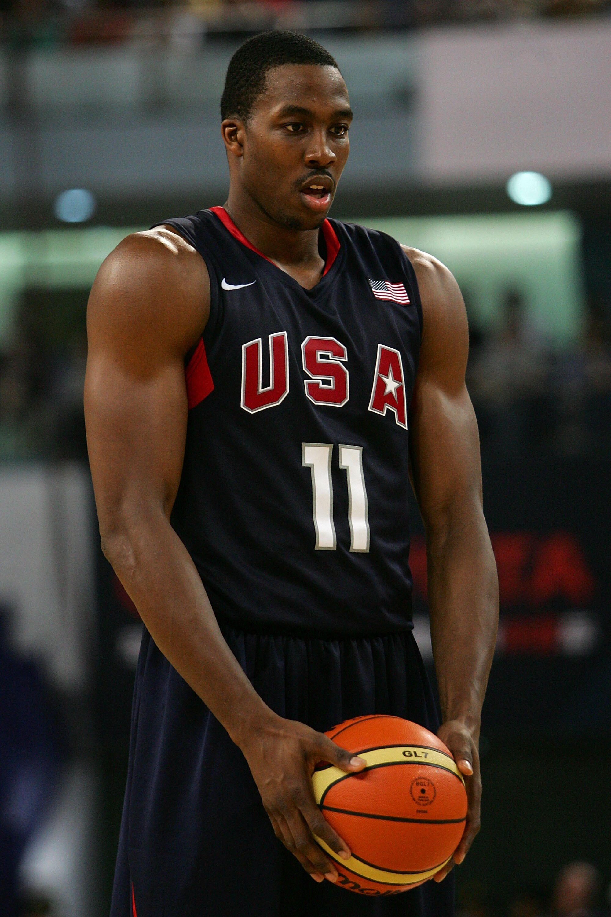SHANGHAI, CHINA - AUGUST 05:  Dwight Howard #11 of the USA Basketball Men's Senior National Team holds a ball during the USA Basketball International Challenge exhibition game against the Australia National Team at the Qizhong Arena on August 5, 2008 in S