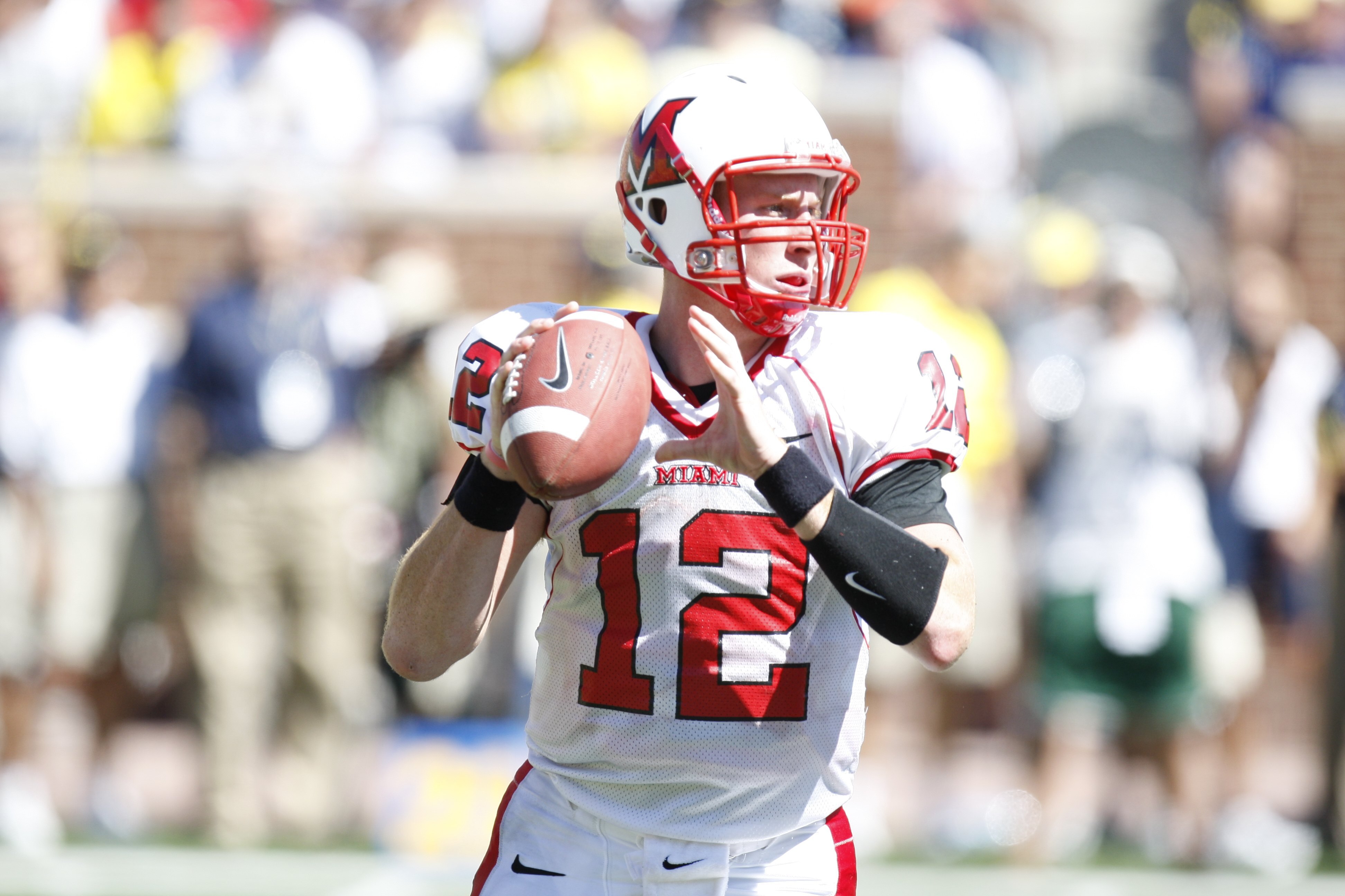 ANN ARBOR, MI - SEPTEMBER 6:  Quarterback Daniel Raudabaugh  #12 of the Miami of Ohio Red Hawks looks to make a pass play during the game against the Michigan Wolverines on September 6, 2008 at Michigan Stadium in Ann Arbor, Michigan.  The Wolverines defe