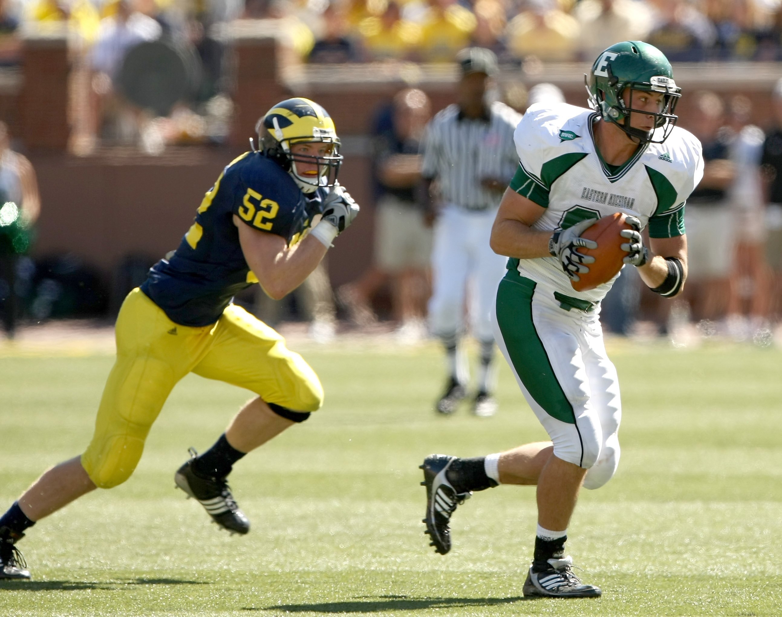 ANN ARBOR, MI - SEPTEMBER 19:  Tight end Ben Thayer #81 of the Eastern Michigan Eagles carries the ball as he is chased by lilnebacker Kevin Leach #52 of the Michigan Wolverines at Michigan Stadium on September 19, 2009 in Ann Arbor, Michigan.  Michigan w